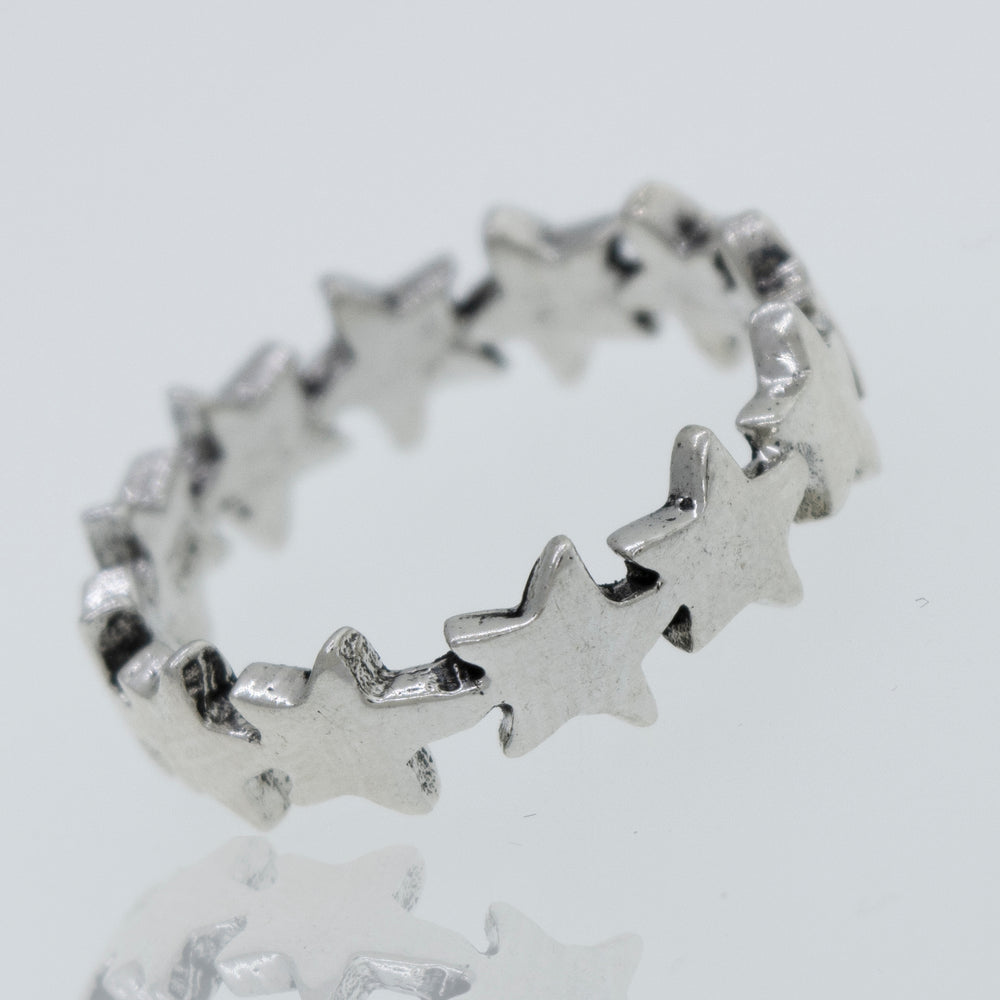 A Super Silver Star Pattern Ring on a white surface.