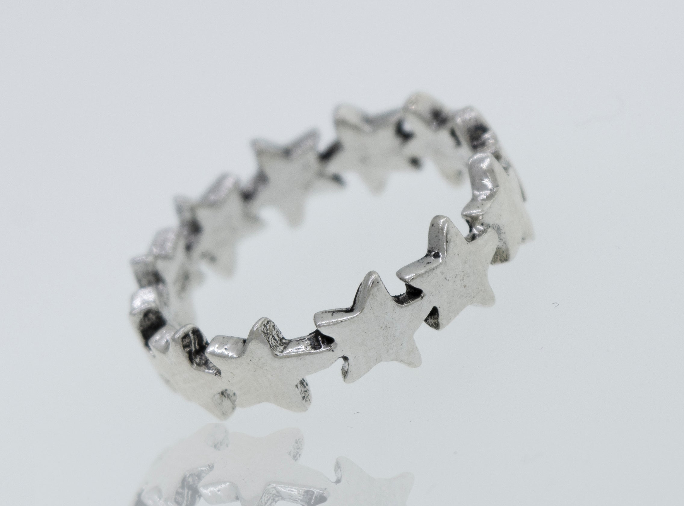 A Super Silver Star Pattern Ring on a white surface.