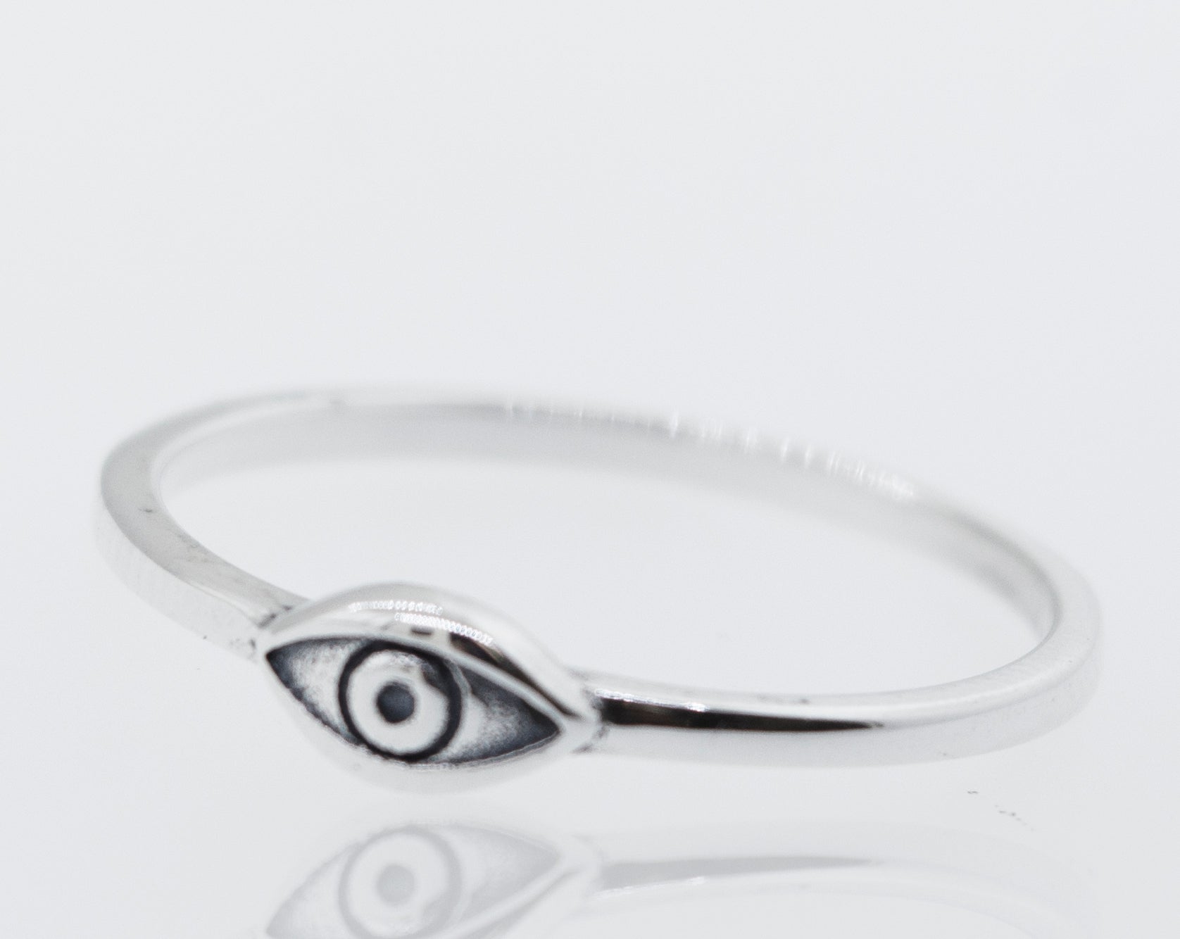 A minimalist Simple Eye Ring in silver with an evil eye.