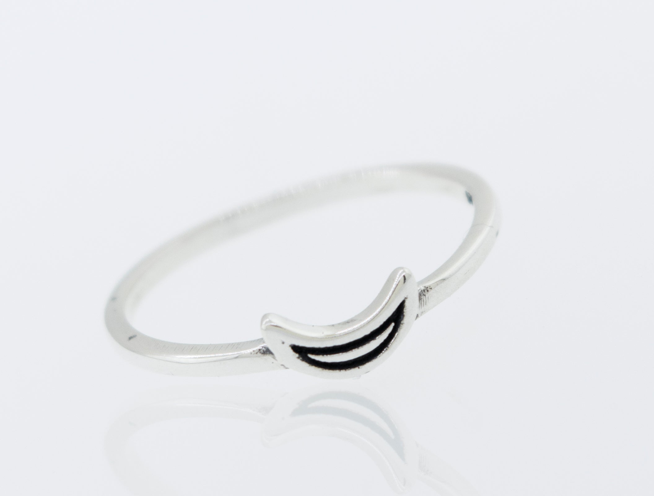 A Tiny Crescent Moon Ring with a smiley face on it.