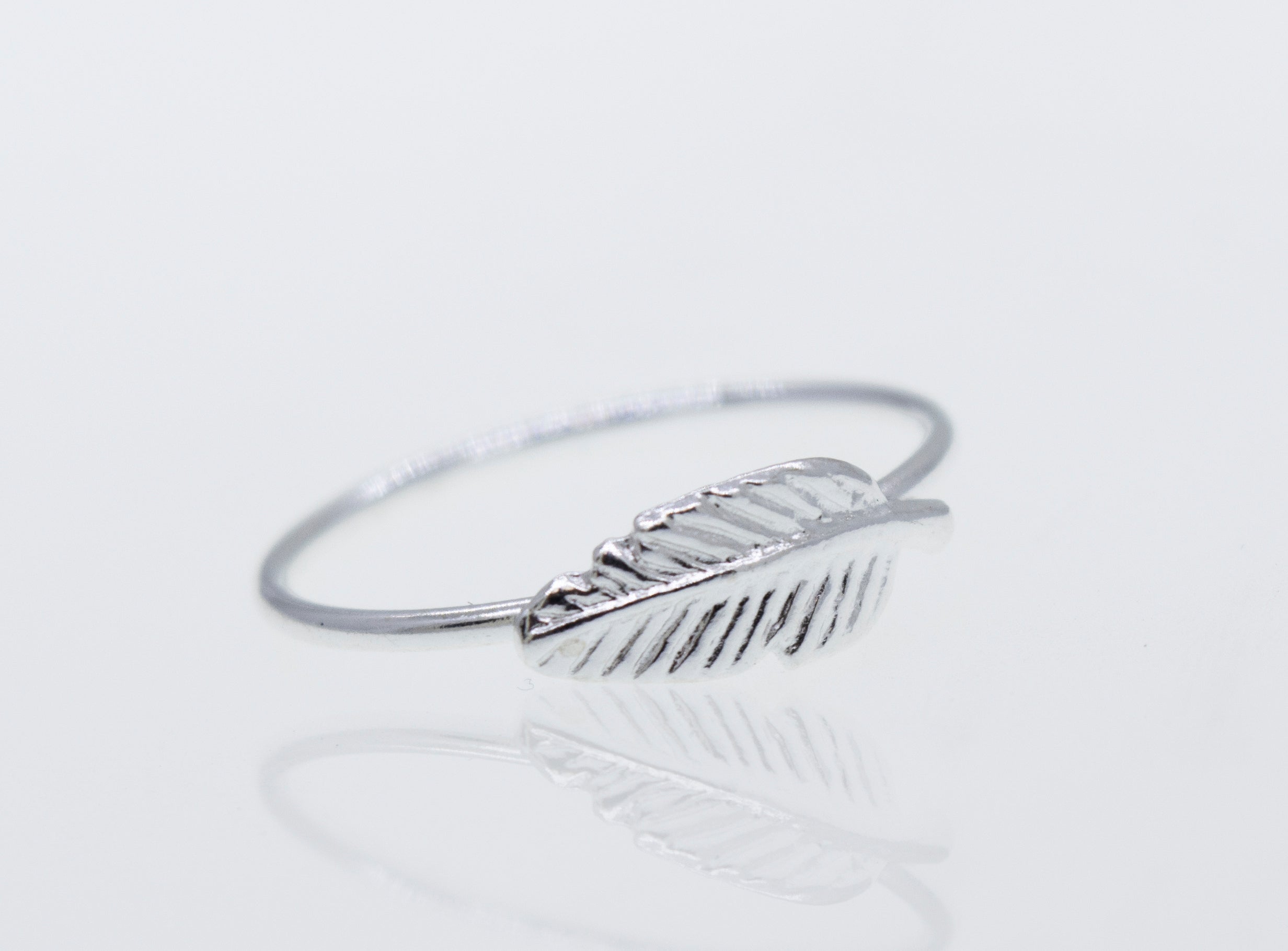A Super Silver Silver Feather Ring on a white surface.