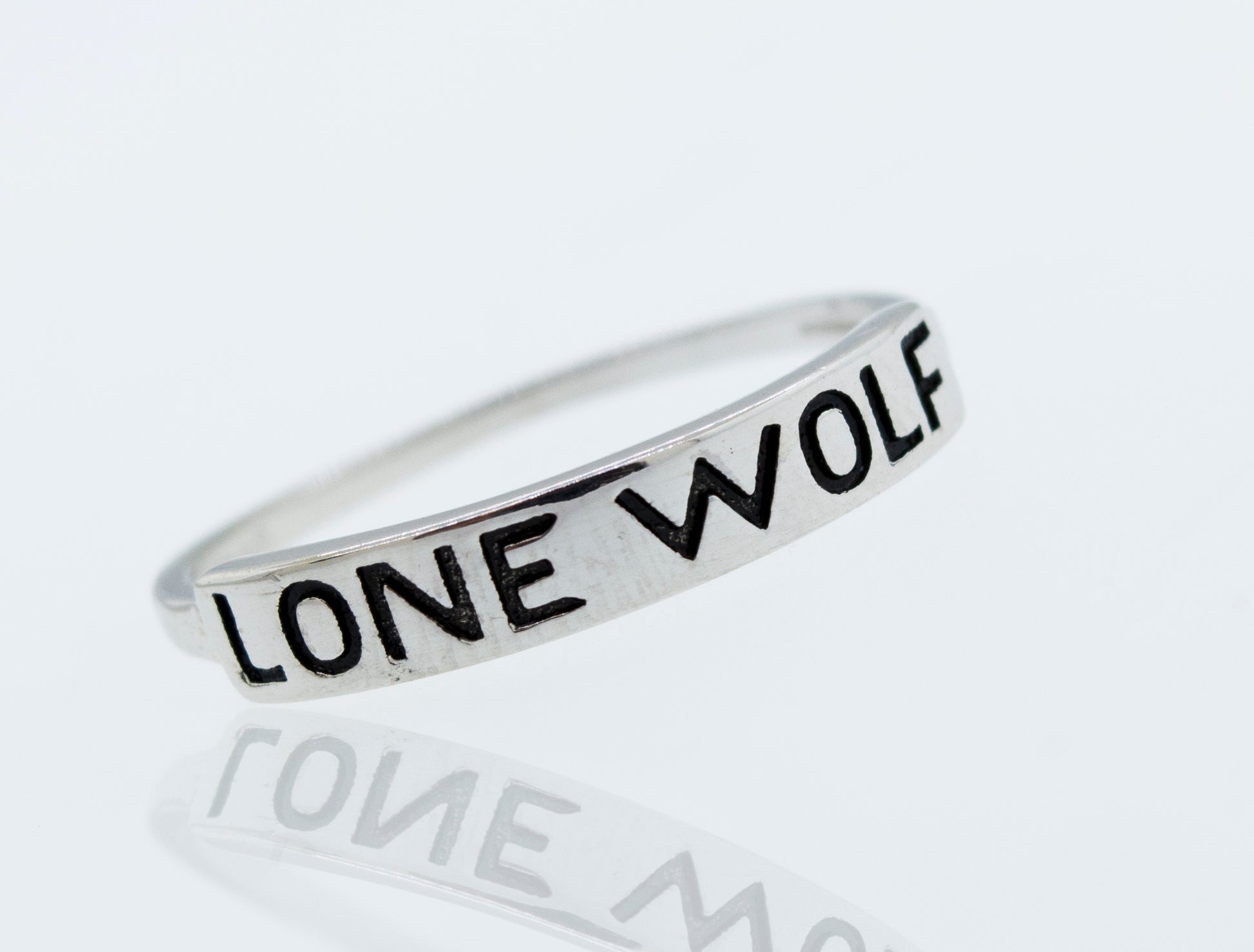 A Super Silver Sterling Silver Lone Wolf Ring with the word "lone wolf" engraved on it.