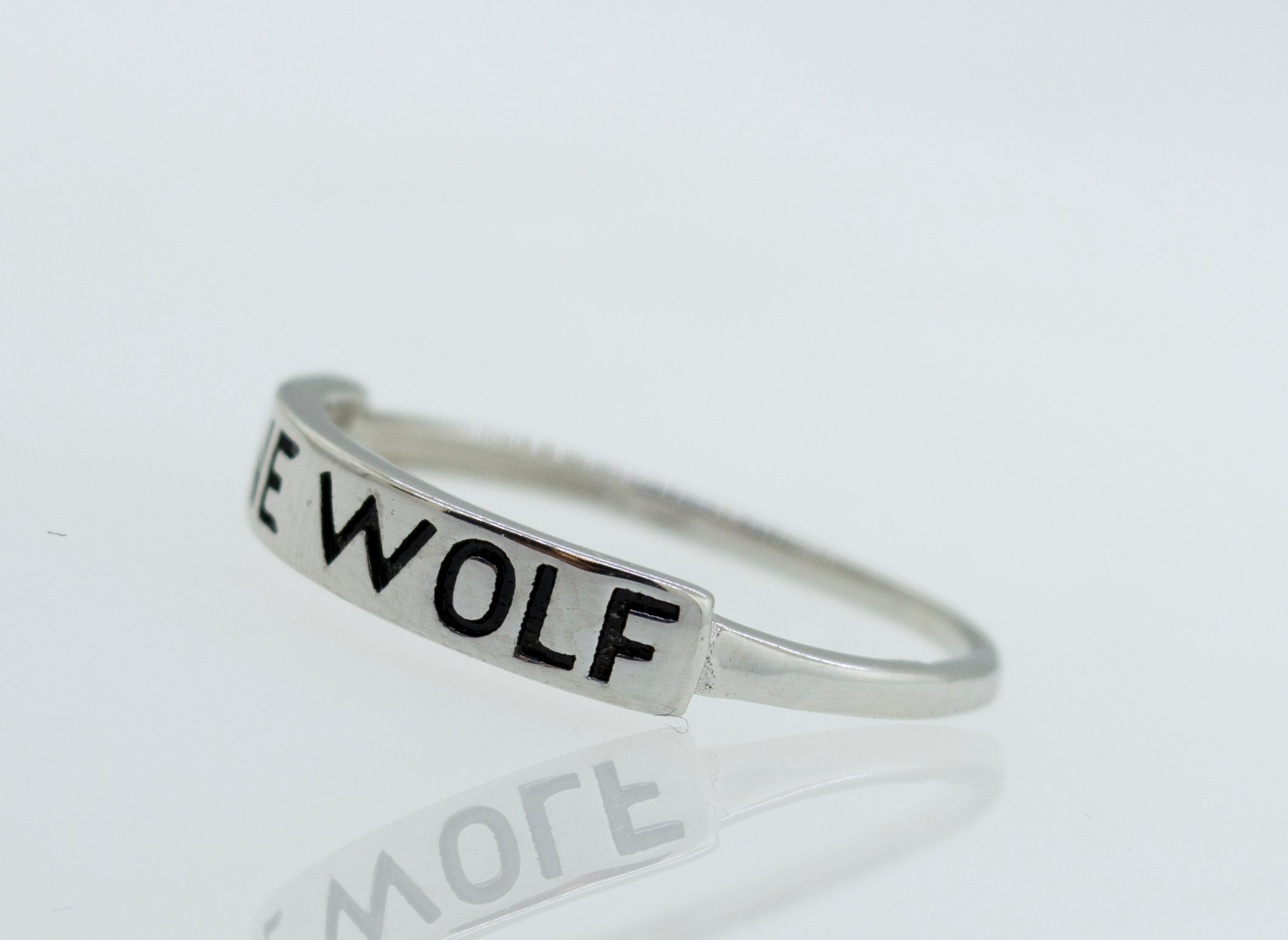 A Super Silver Silver Lone Wolf Ring with the word wolf on it.