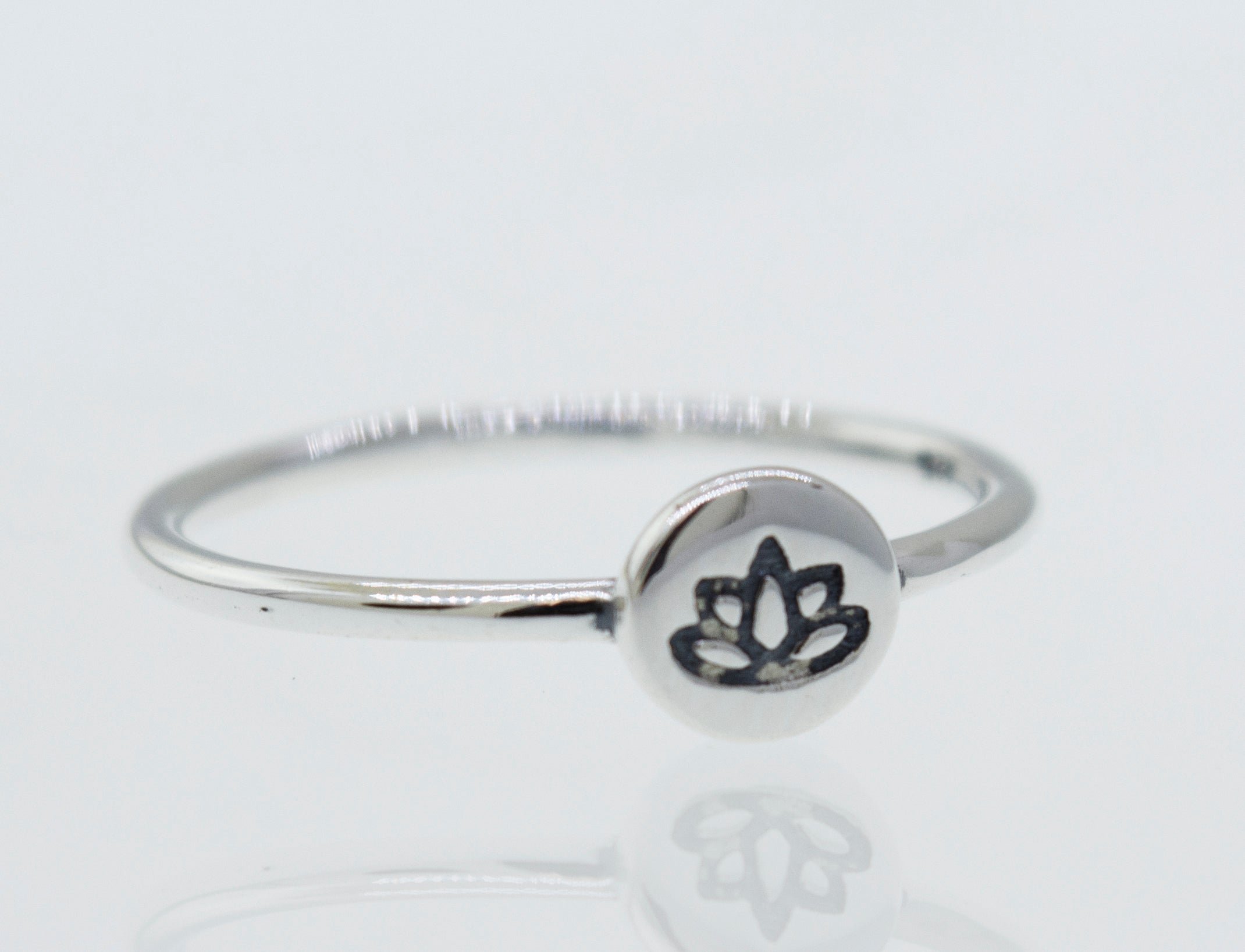 A minimalist Stackable Silver Lotus Ring featuring a lotus flower.