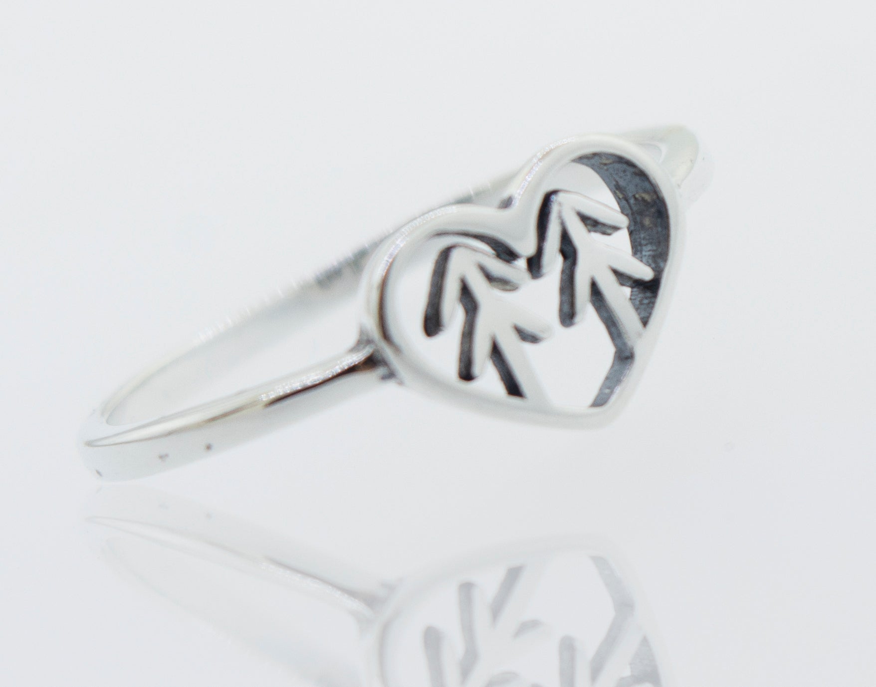 A Heart With Trees Silver Ring with a pine tree in the middle, representing love and nature.