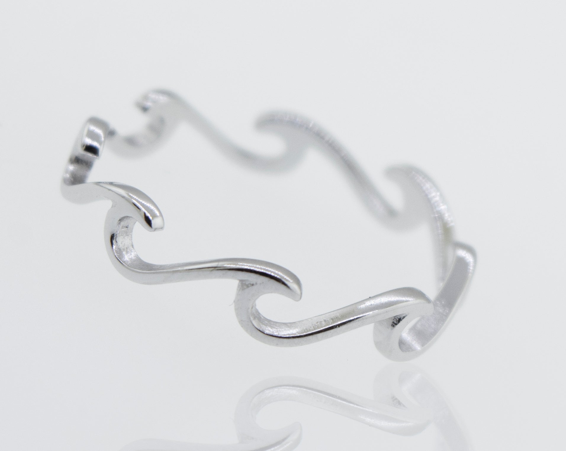 A minimalist Wave Ring with a wave design, inspired by the ocean.