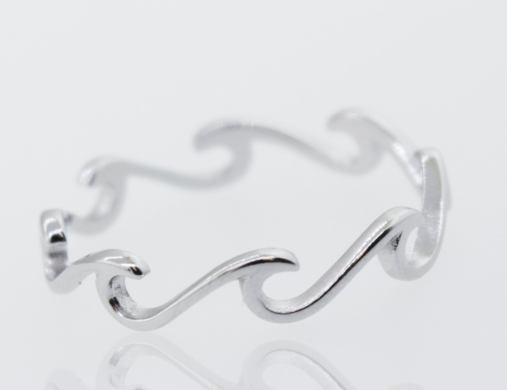 A minimalist and modern Wave Ring with waves on it.