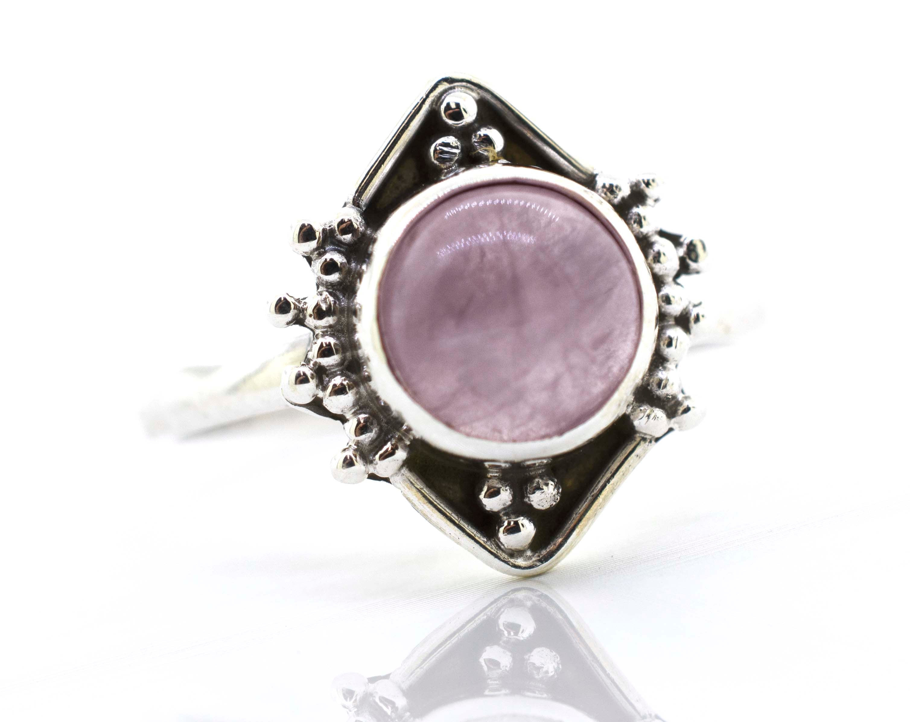 A Super Silver round gemstone ring with oxidized diamond shape pattern in the center.