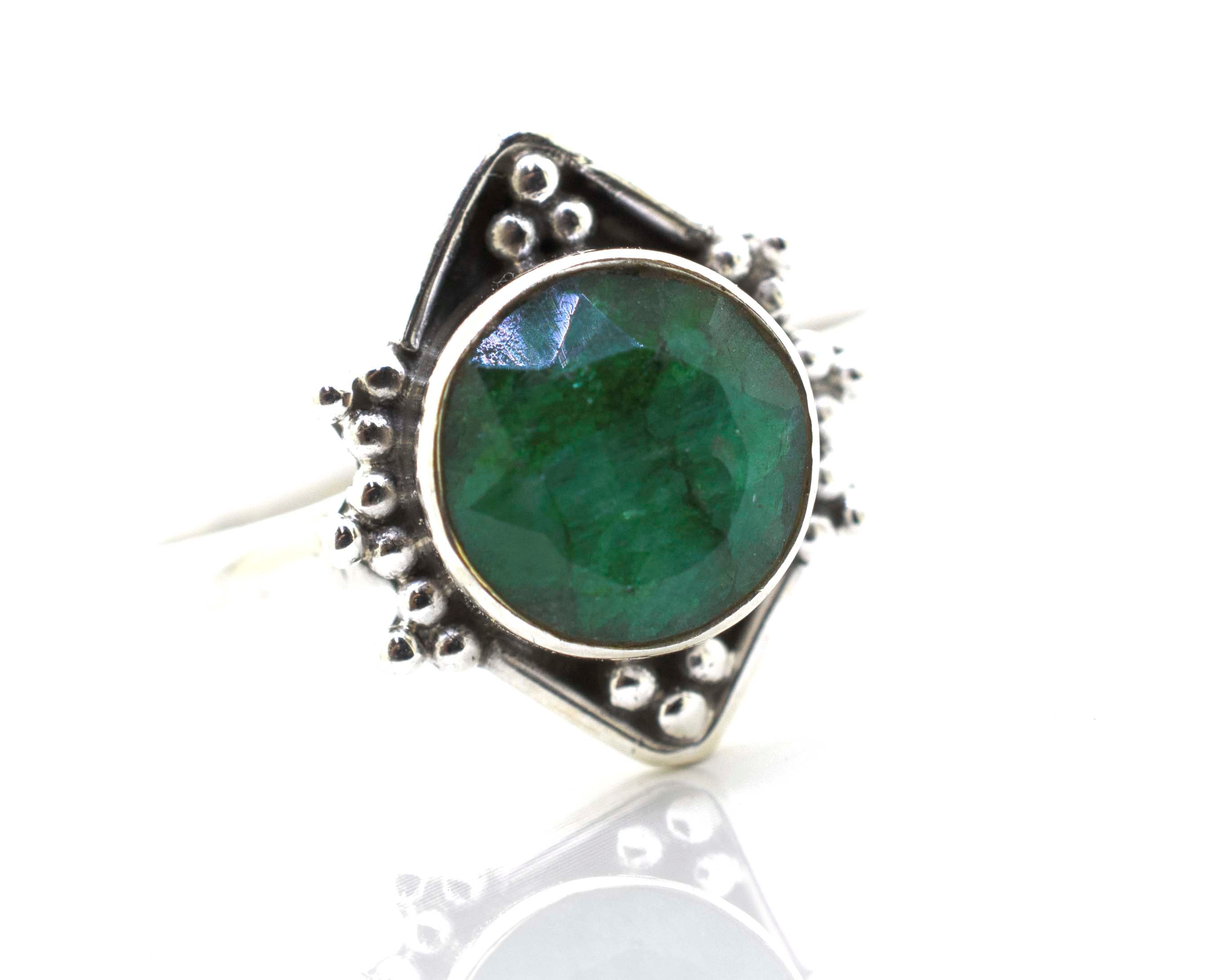A Super Silver round gemstone ring with oxidized diamond shape pattern, beautifully placed on a pristine white surface.