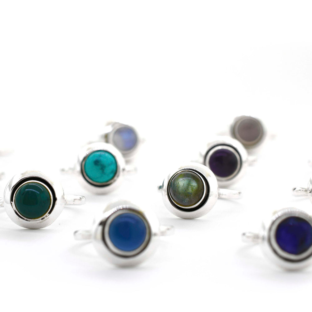 A boho-inspired collection of Round Gemstone Rings With Oxidized Outline, featuring various colored stones crafted in sterling silver, perfect for the free-spirited hippie.