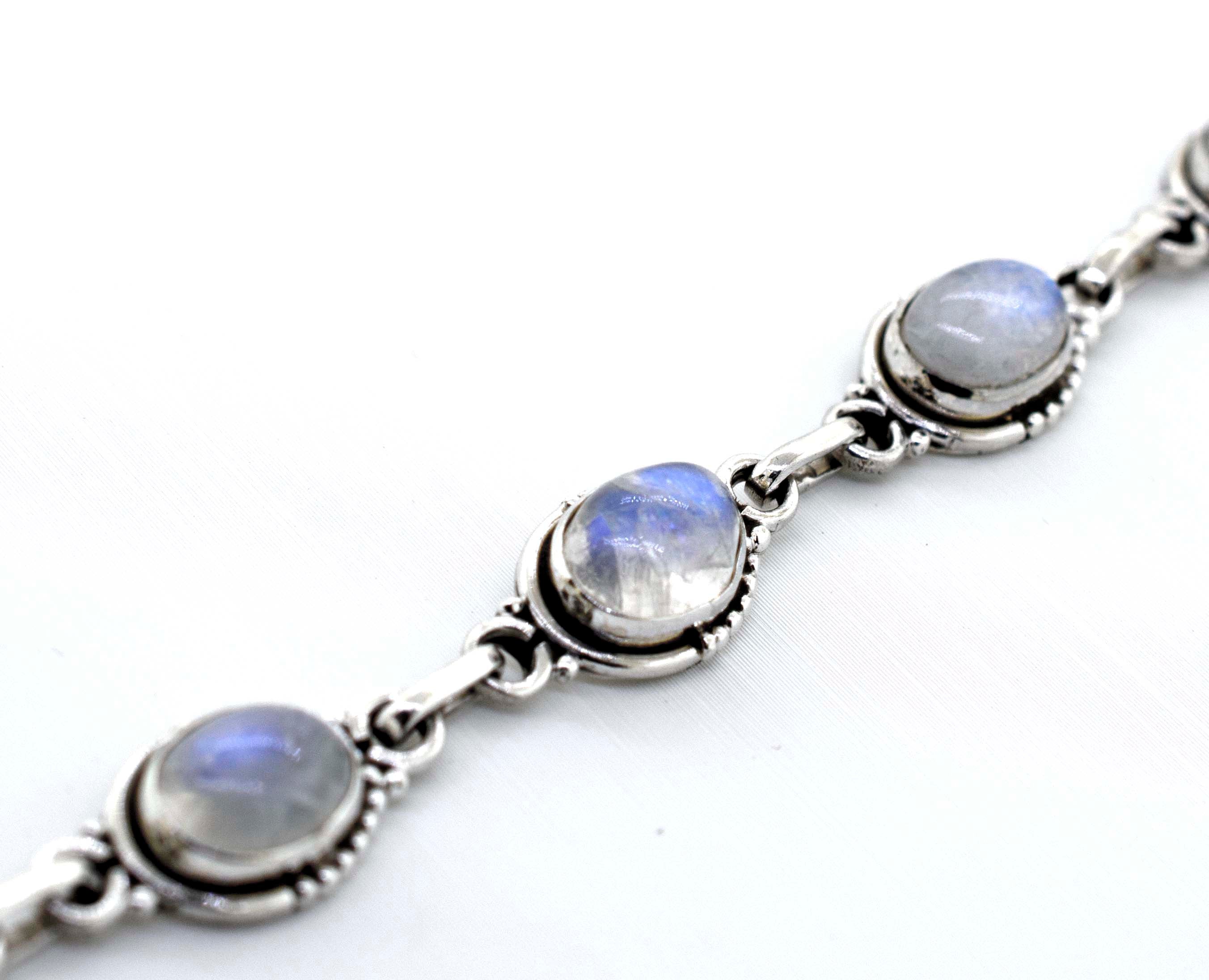 A "Super Silver Oval Gemstone Bracelet With Half Ball Border" adorned with moonstones, a captivating gemstone.