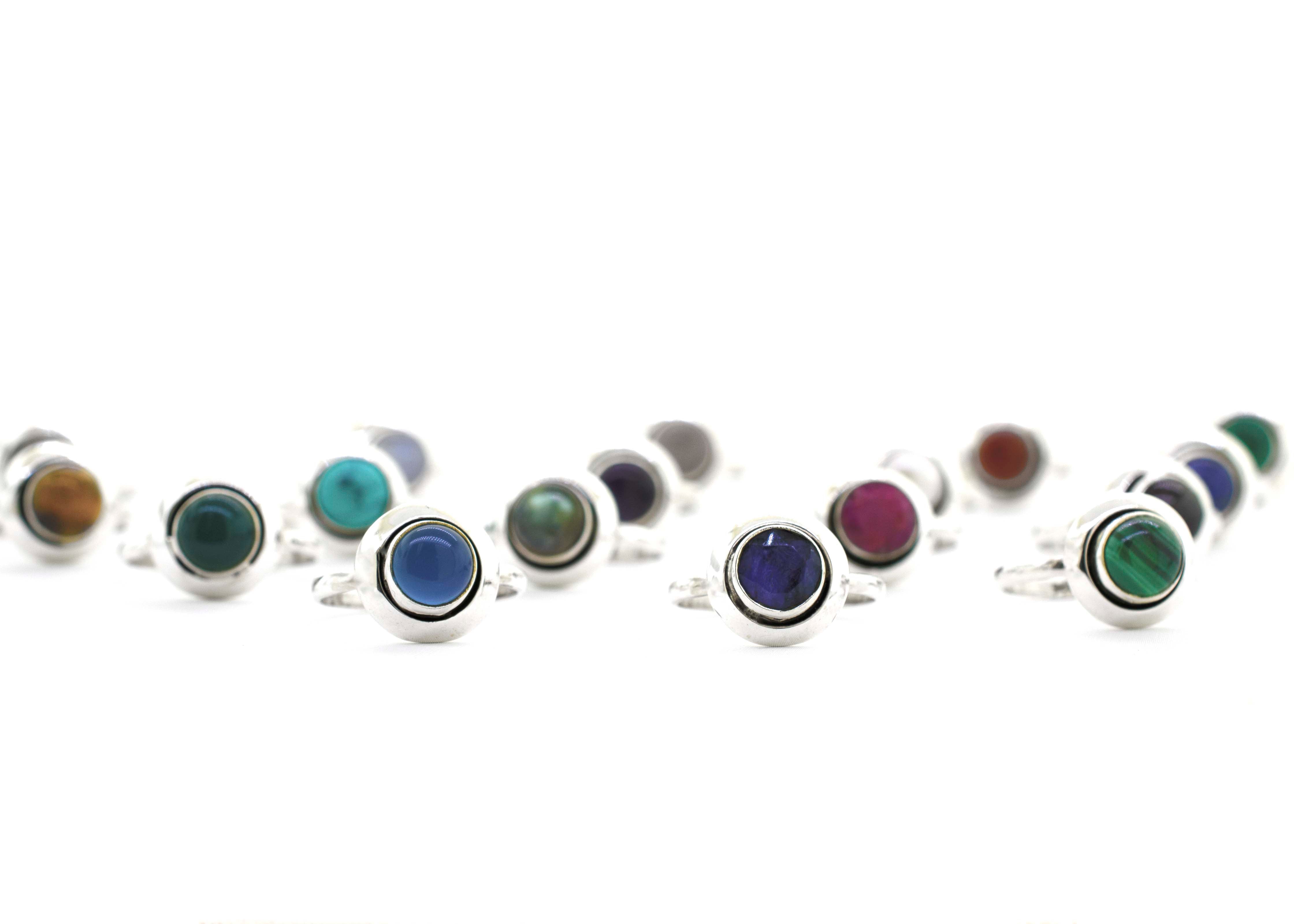 A group of Round Gemstone Rings With Oxidized Outline with a boho vibe on a white background.