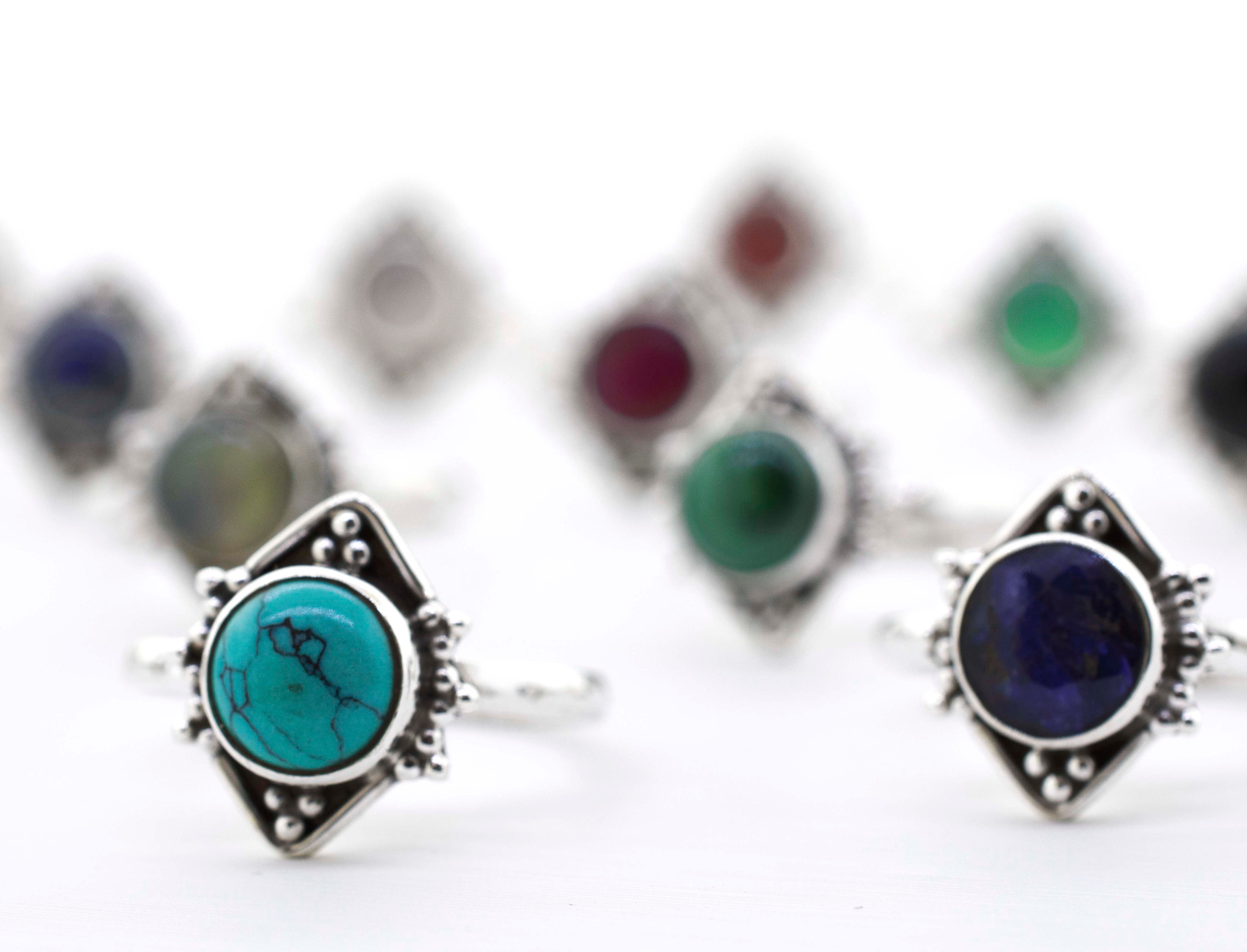A group of Round Gemstone Rings With Oxidized Diamond Shape Pattern on a white surface, including sterling silver.