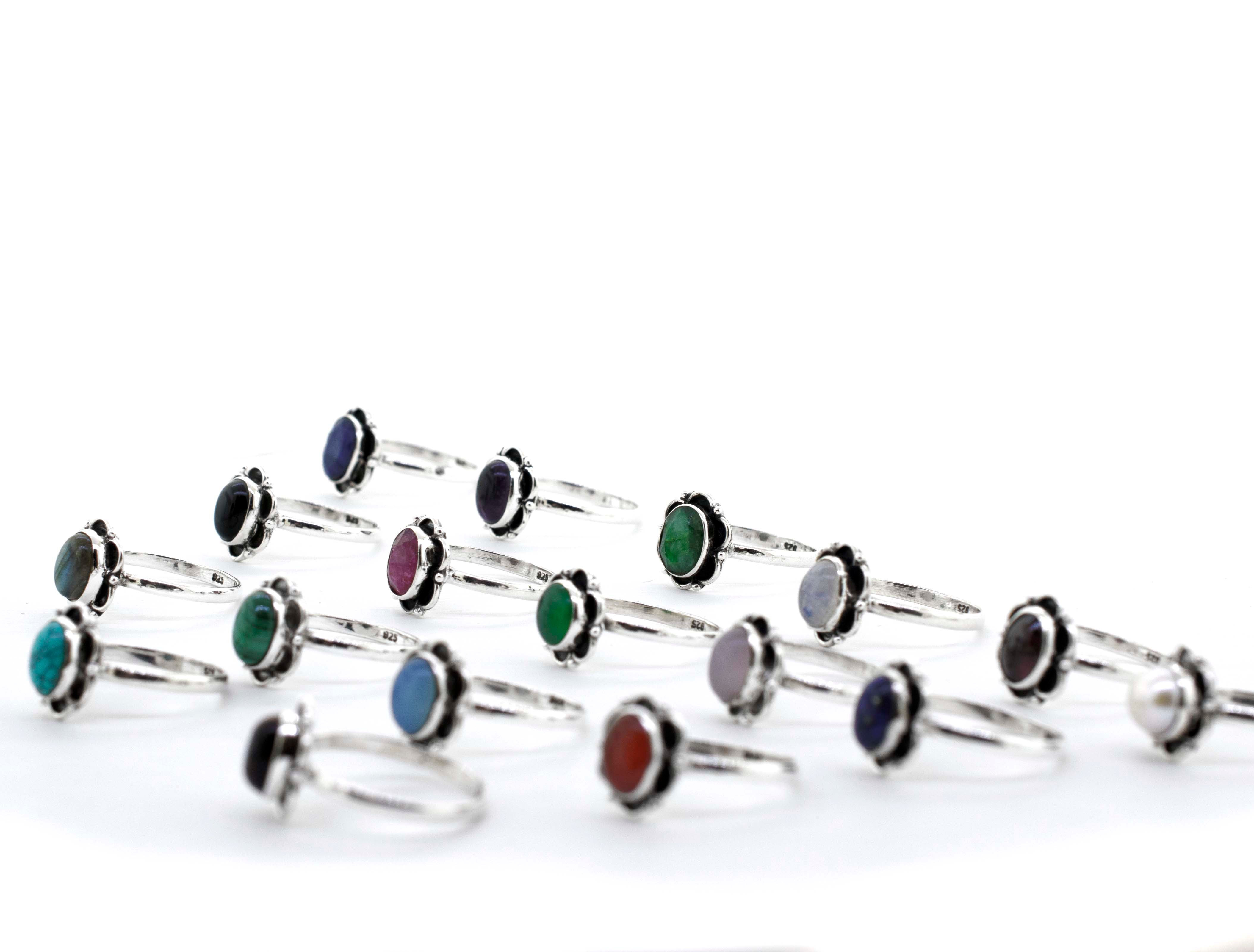 A group of Gemstone Rings With Oxidized Flower Design, featuring Santa Cruz and hippie vibes.