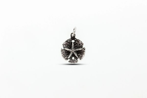 A small oxidized sand dollar charm from Super Silver, reminiscent of the beach, showcased on a clean white background.