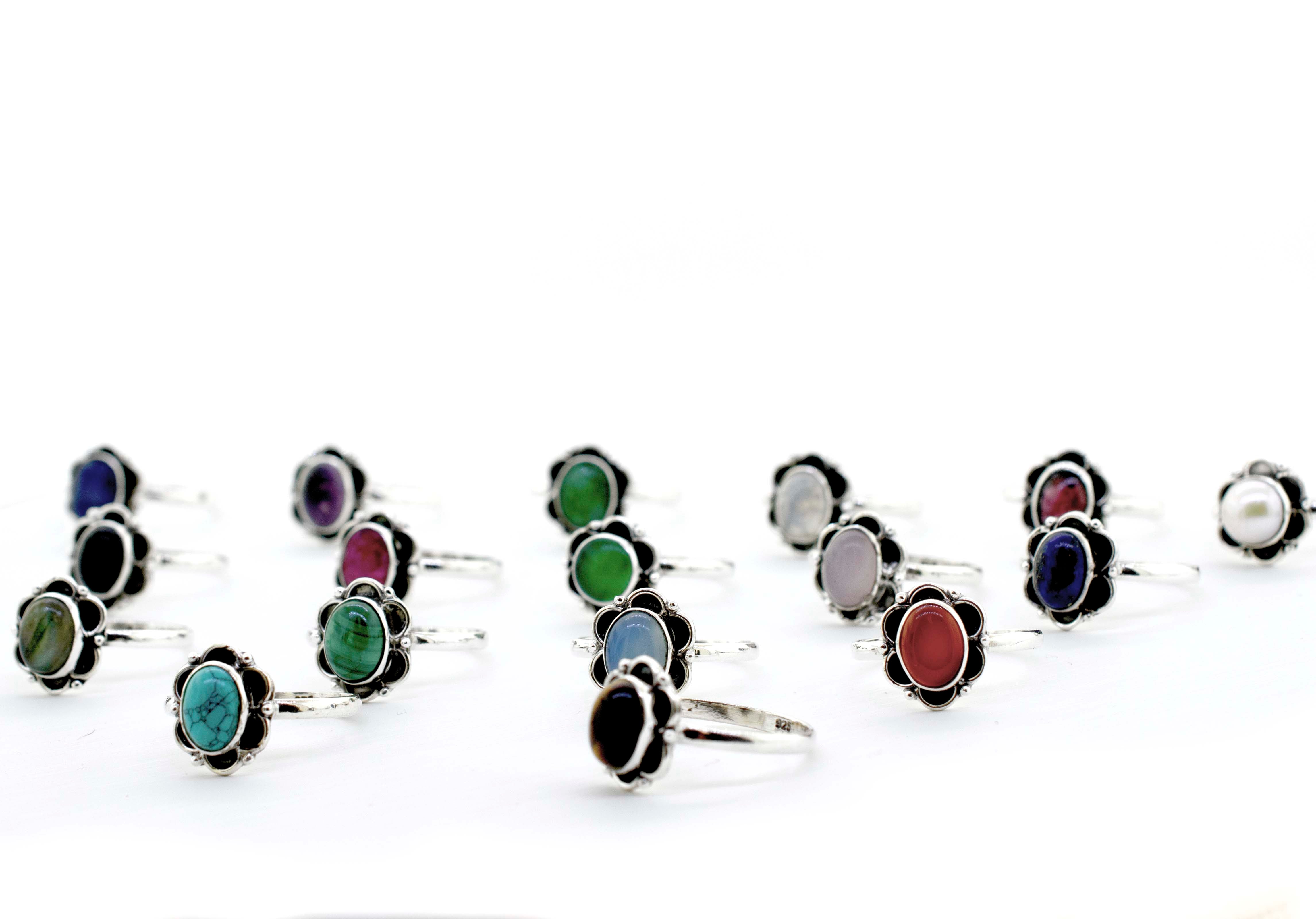 A group of colorful Gemstone Rings With Oxidized Flower Design on a white background.