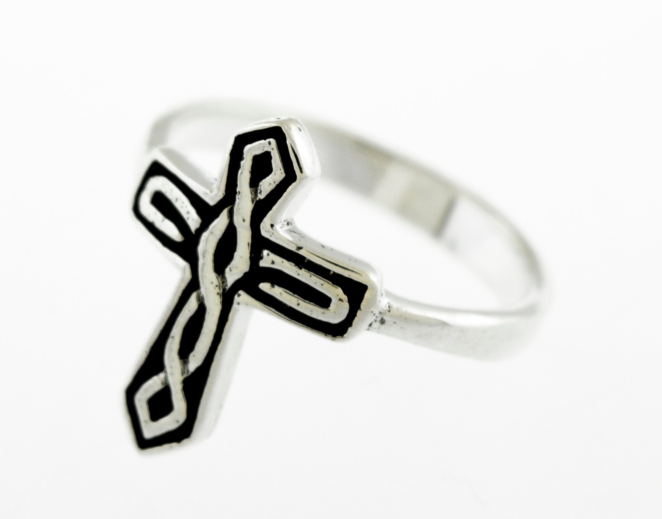 A Super Silver Cross Ring With Celtic Weave with a darkened finish and intricate black and white designs inspired by Celtic weave.