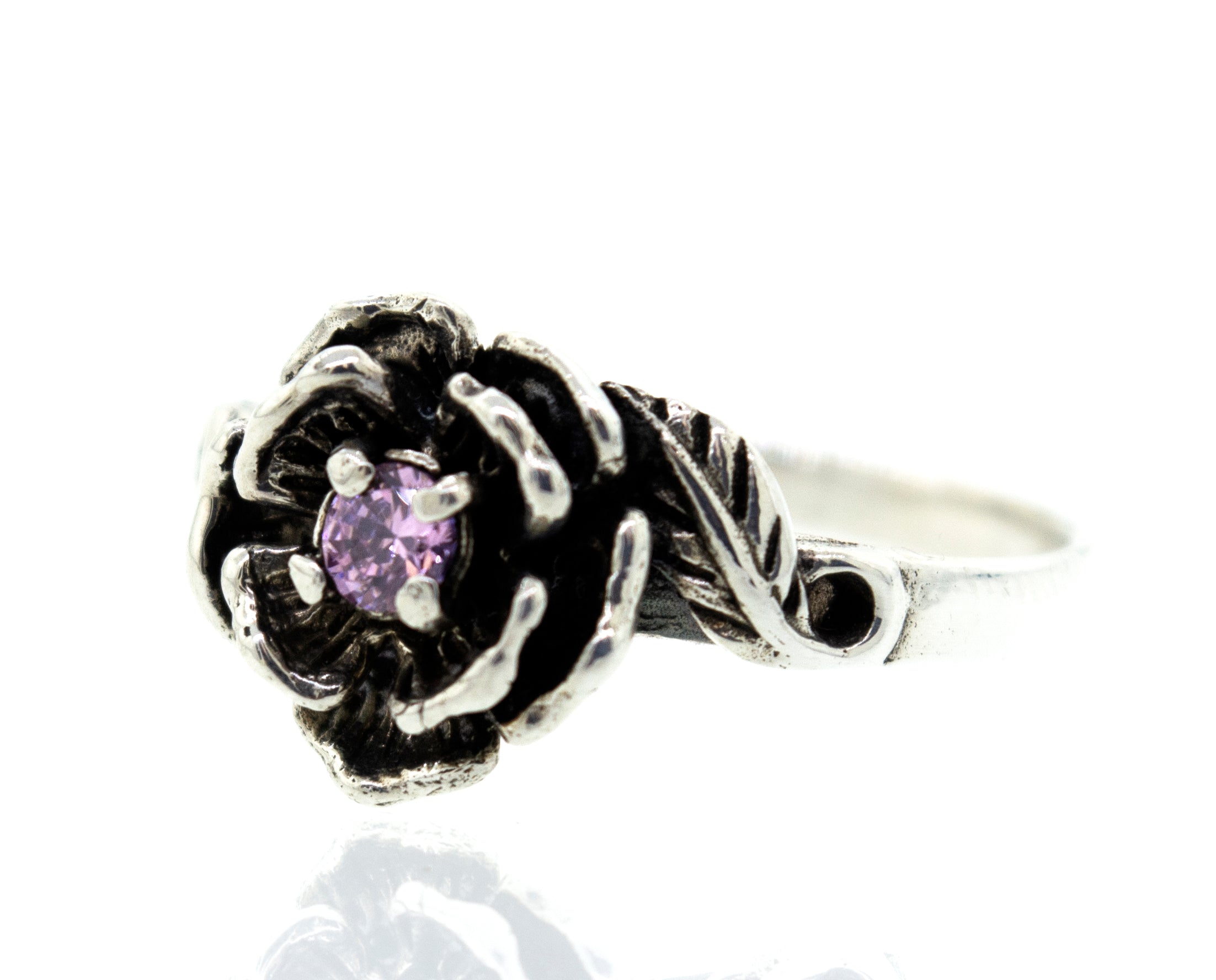 A Rose Ring With Cubic Zirconia Stone featuring a flower design with a small stone, adorned with a purple cubic zirconia in the center.
