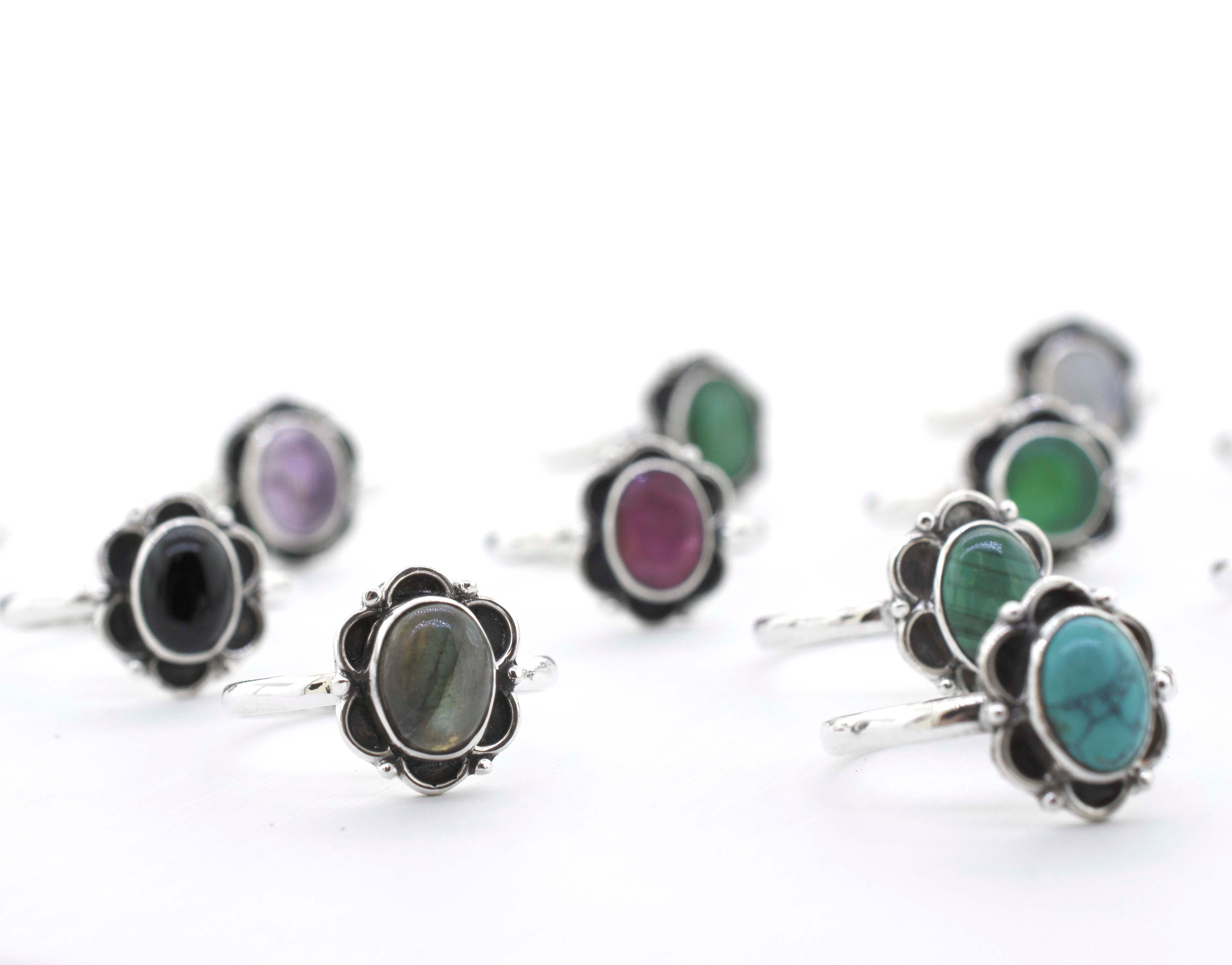 A group of Gemstone Rings With Oxidized Flower Design, inspired by the vibrant colors of Santa Cruz.