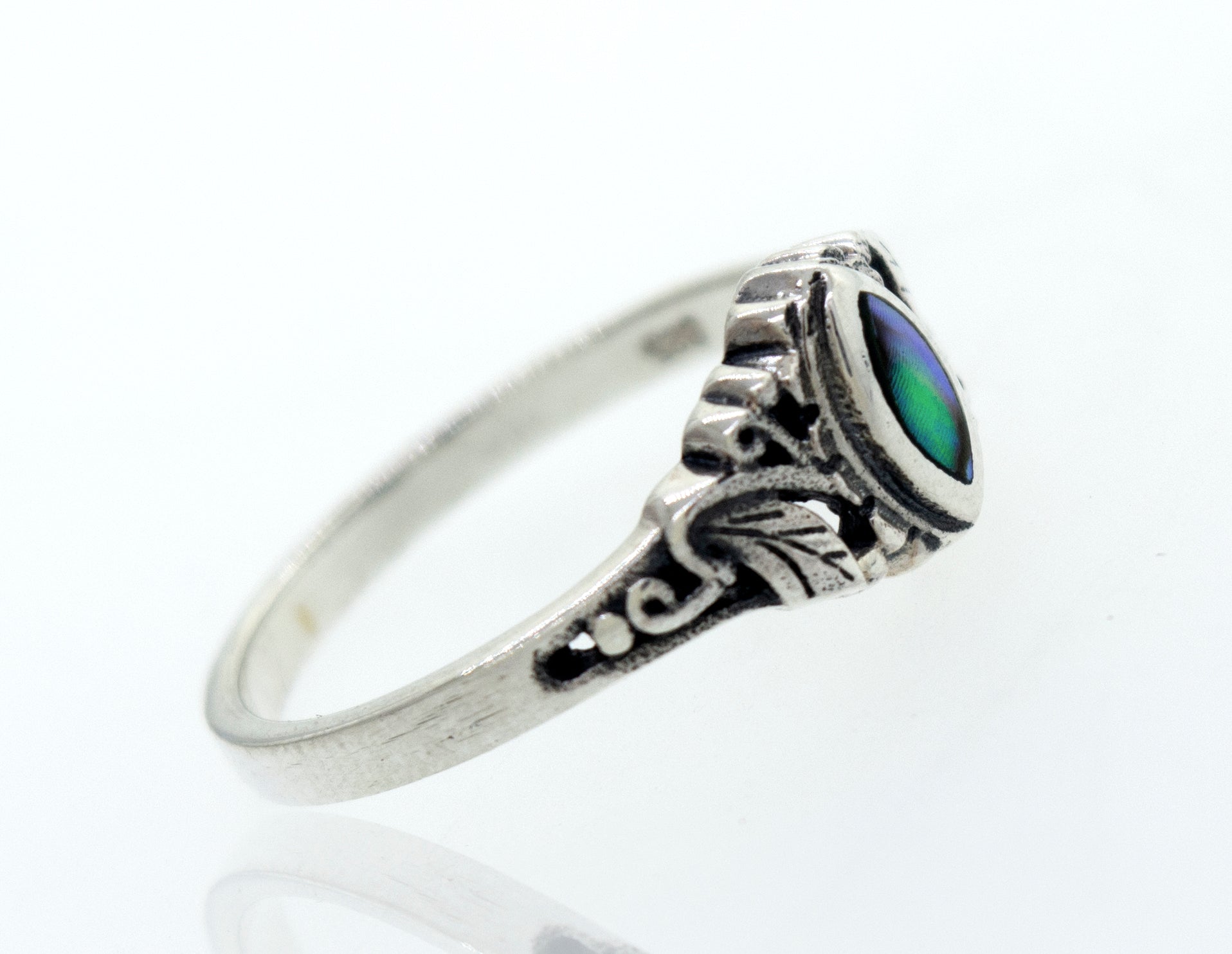 A Dainty and Intricate Abalone Ring by Super Silver with an oval green stone.
