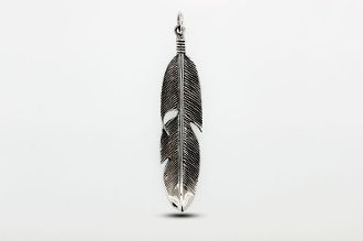 A rustic Super Silver Medium Size Feather Pendant hanging on a white background.