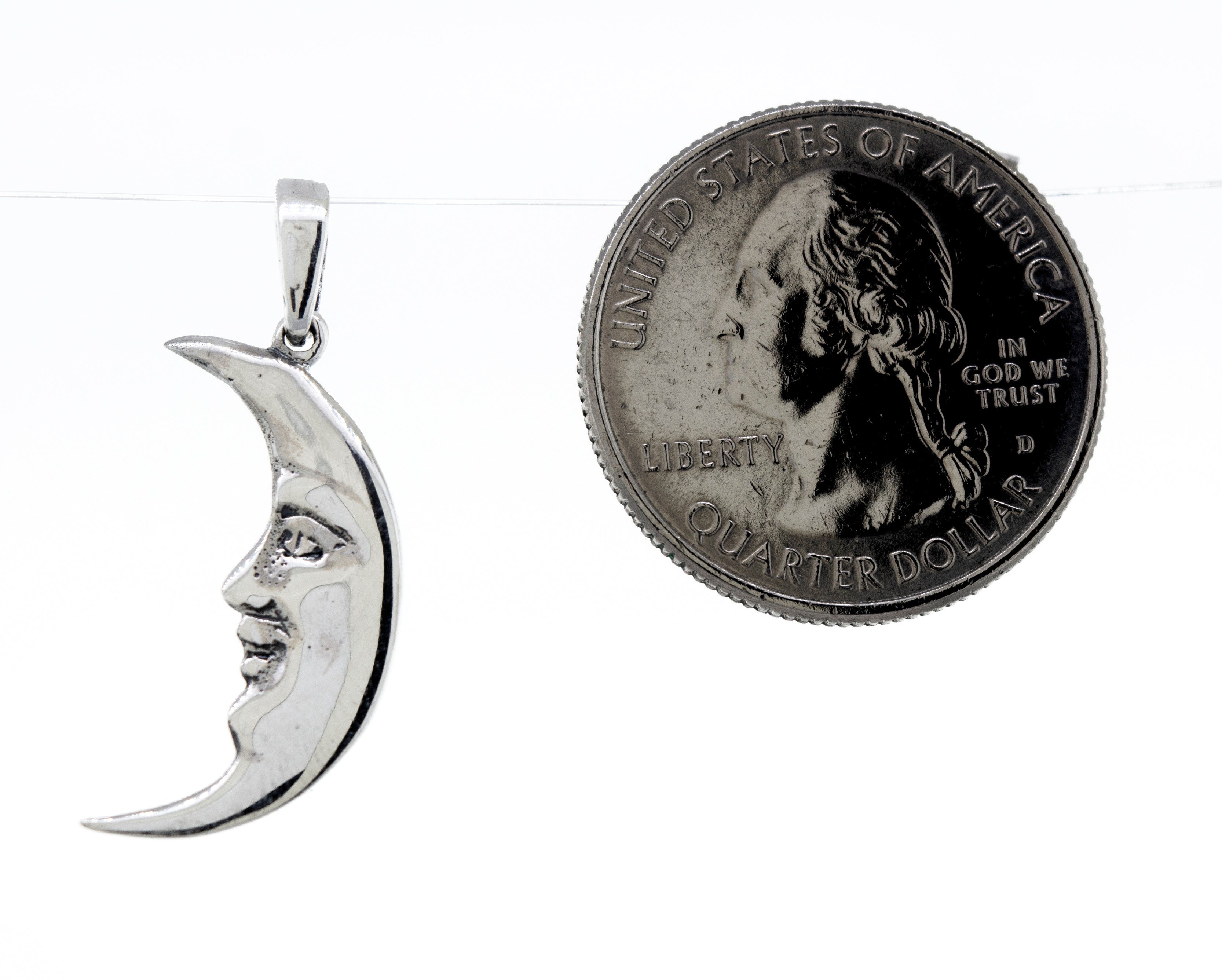 A Super Silver Crescent Man In The Moon Pendant, depicting an elegant moon, accompanied by a delicate coin.