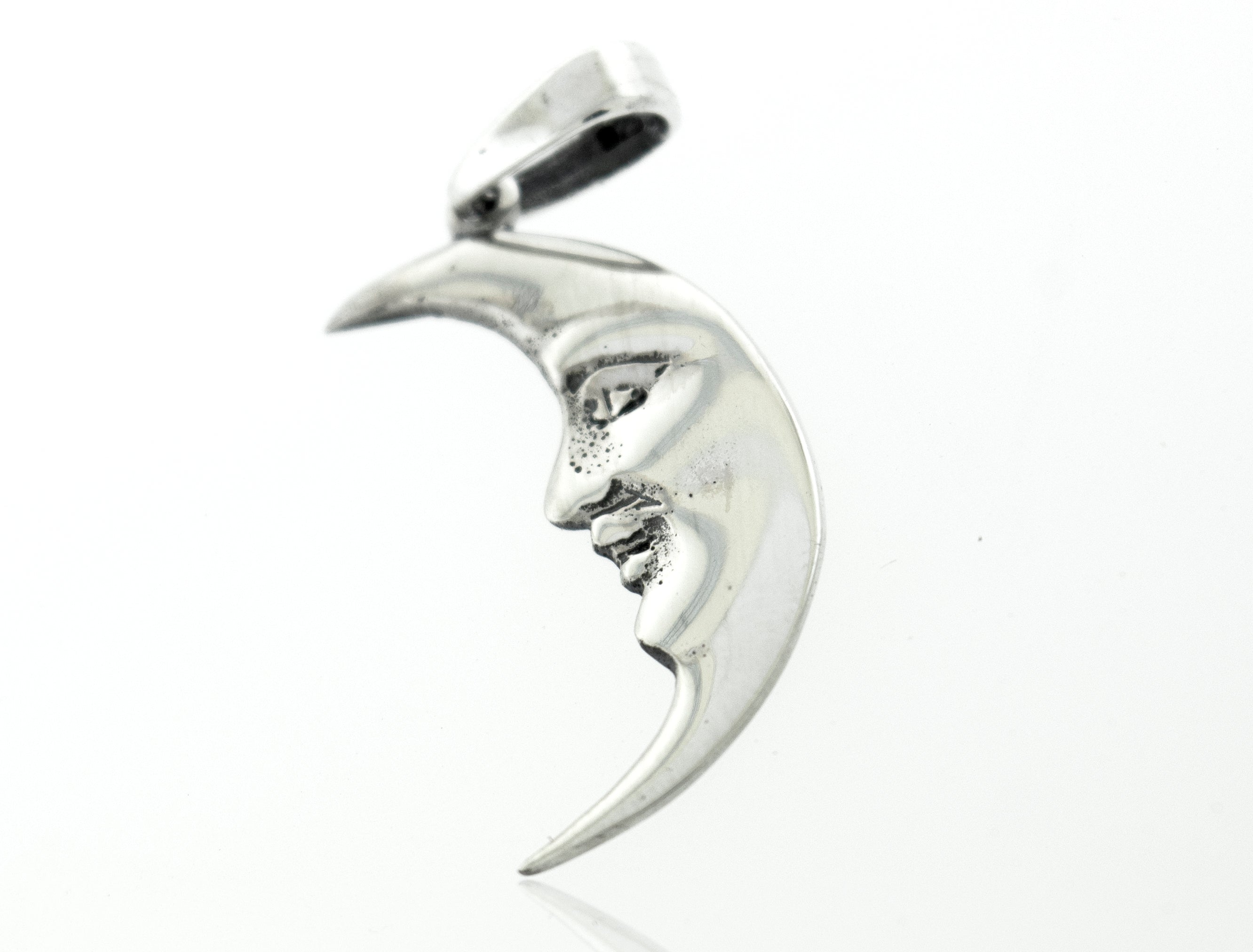 A Super Silver Crescent Man In The Moon Pendant with a graceful face engraved on it.