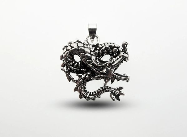 A Super Silver Dragon Pendant featuring a silver dragon with fine details on a white background.