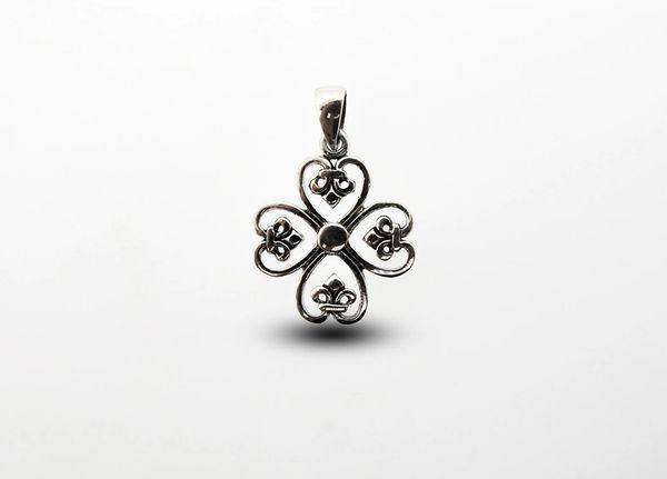 A vintage-style Super Silver pendant with the Clover Cross design on it.