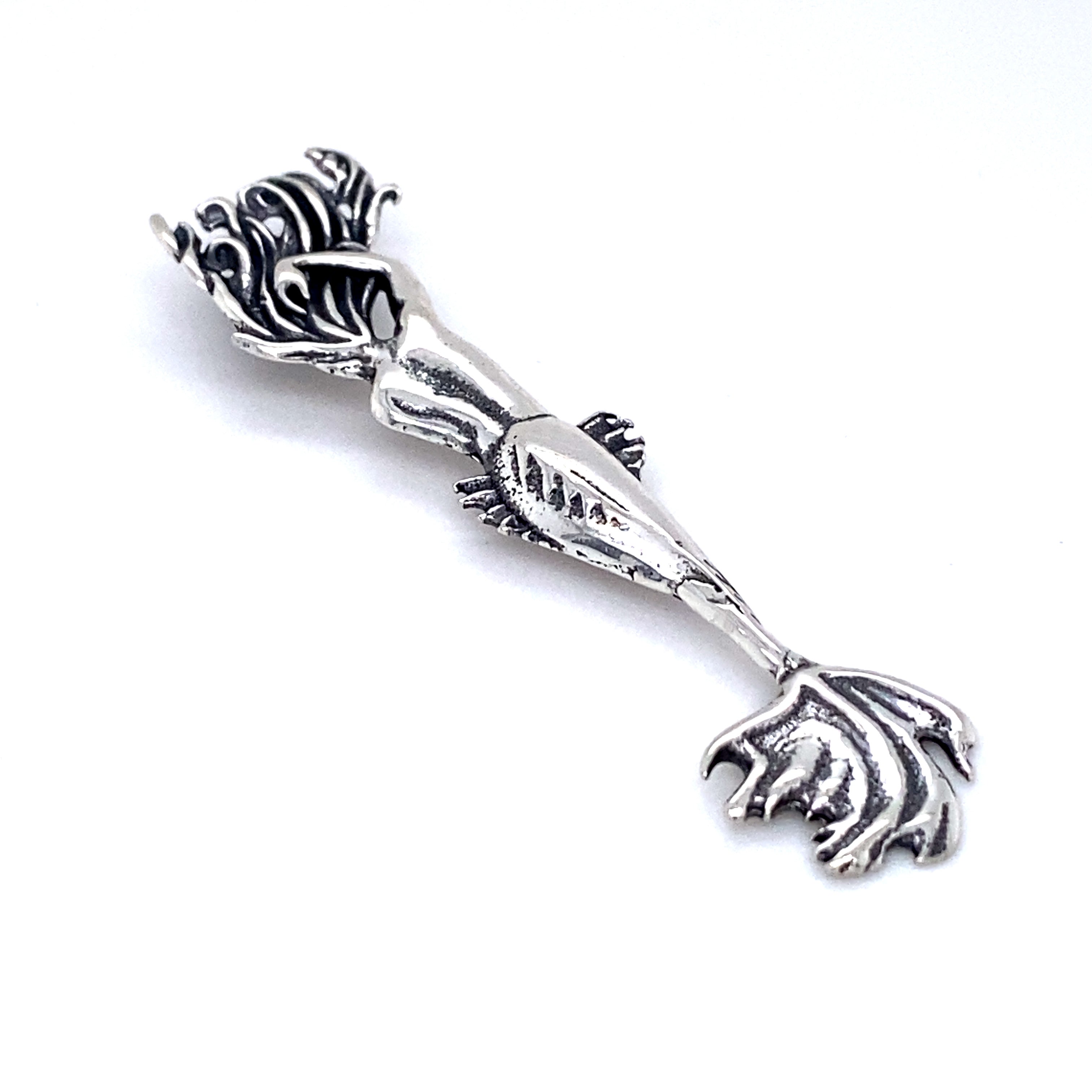 A Super Silver Enticing Mermaid Pendant with a striking pendant on a white surface.