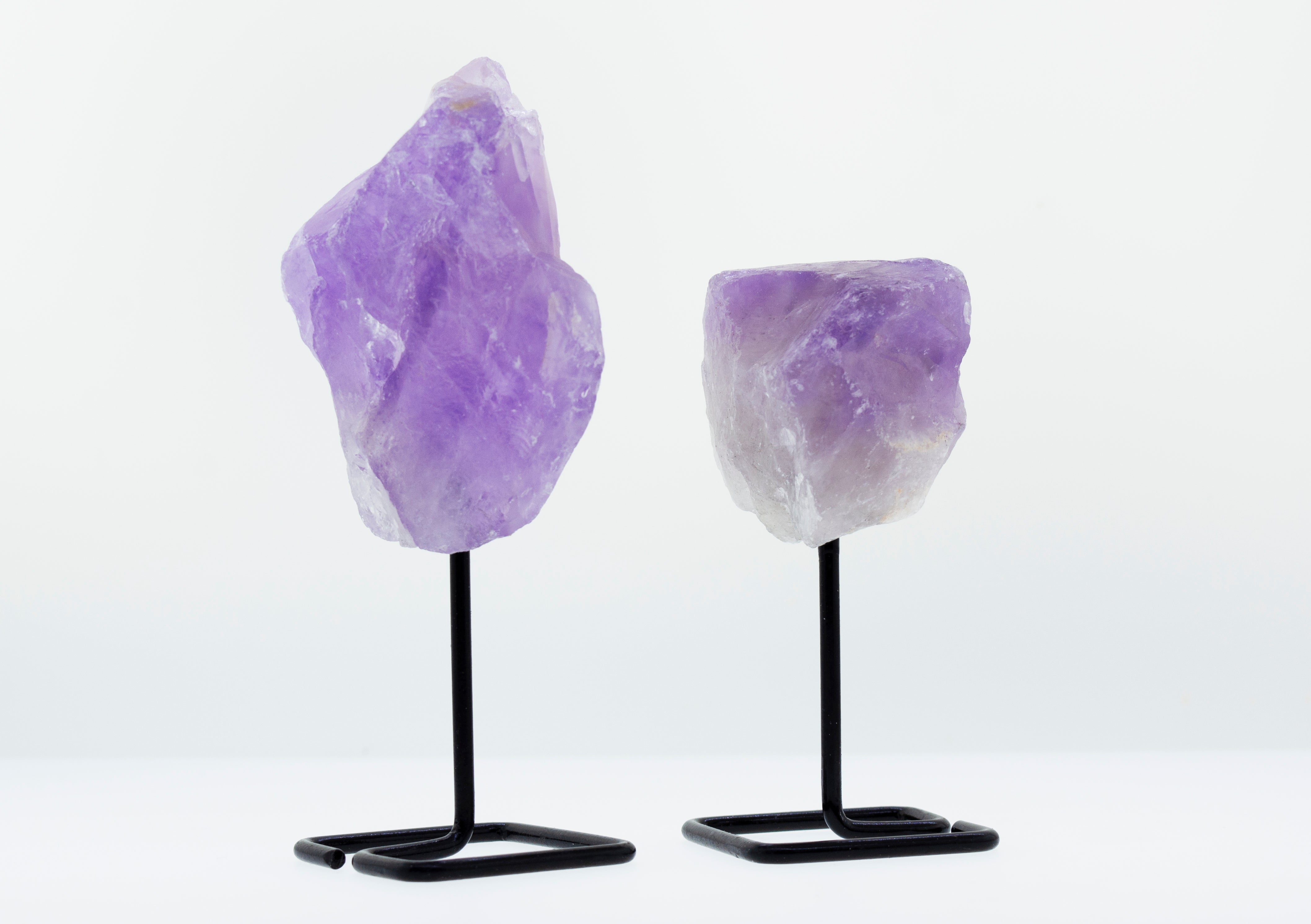 Two pieces of Irregular Shaped Stone With Stand, perfect for decorative purposes.
