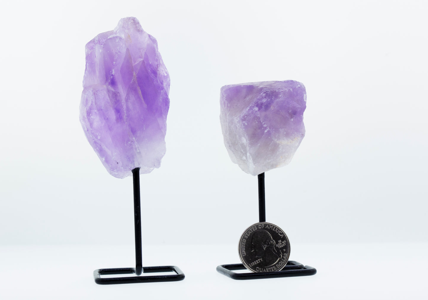 A decorative display featuring an irregular shaped stone with stand on a stylish stand.