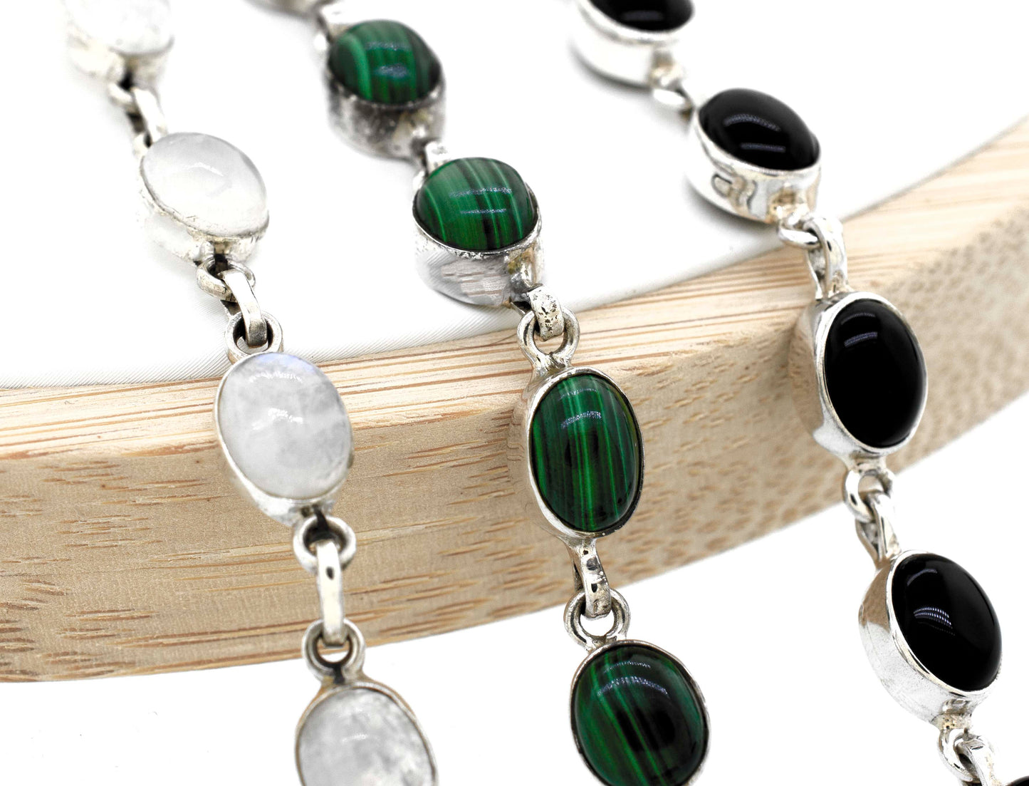 A Super Silver simple oval gemstone bracelet adorned with elegant black and white gemstones.