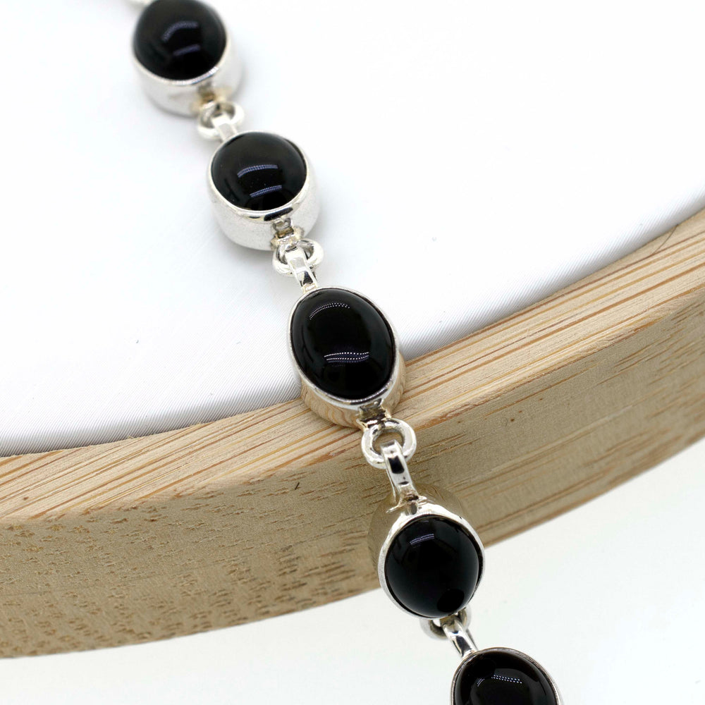 
                  
                    A Super Silver Simple Oval Gemstone Bracelet that combines simplicity and elegance with silver and black onyx beads.
                  
                
