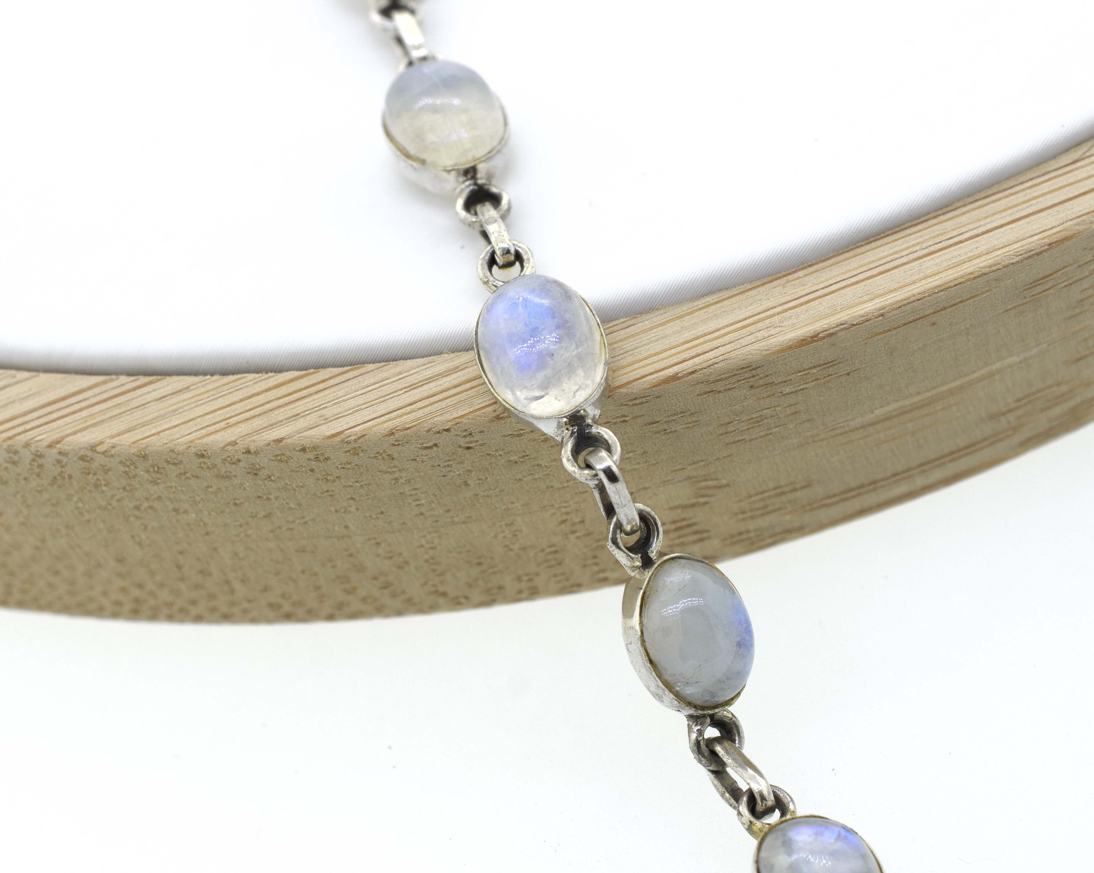 A Super Silver Simple Oval Gemstone Bracelet adorned with moonstones, a timeless gemstone.