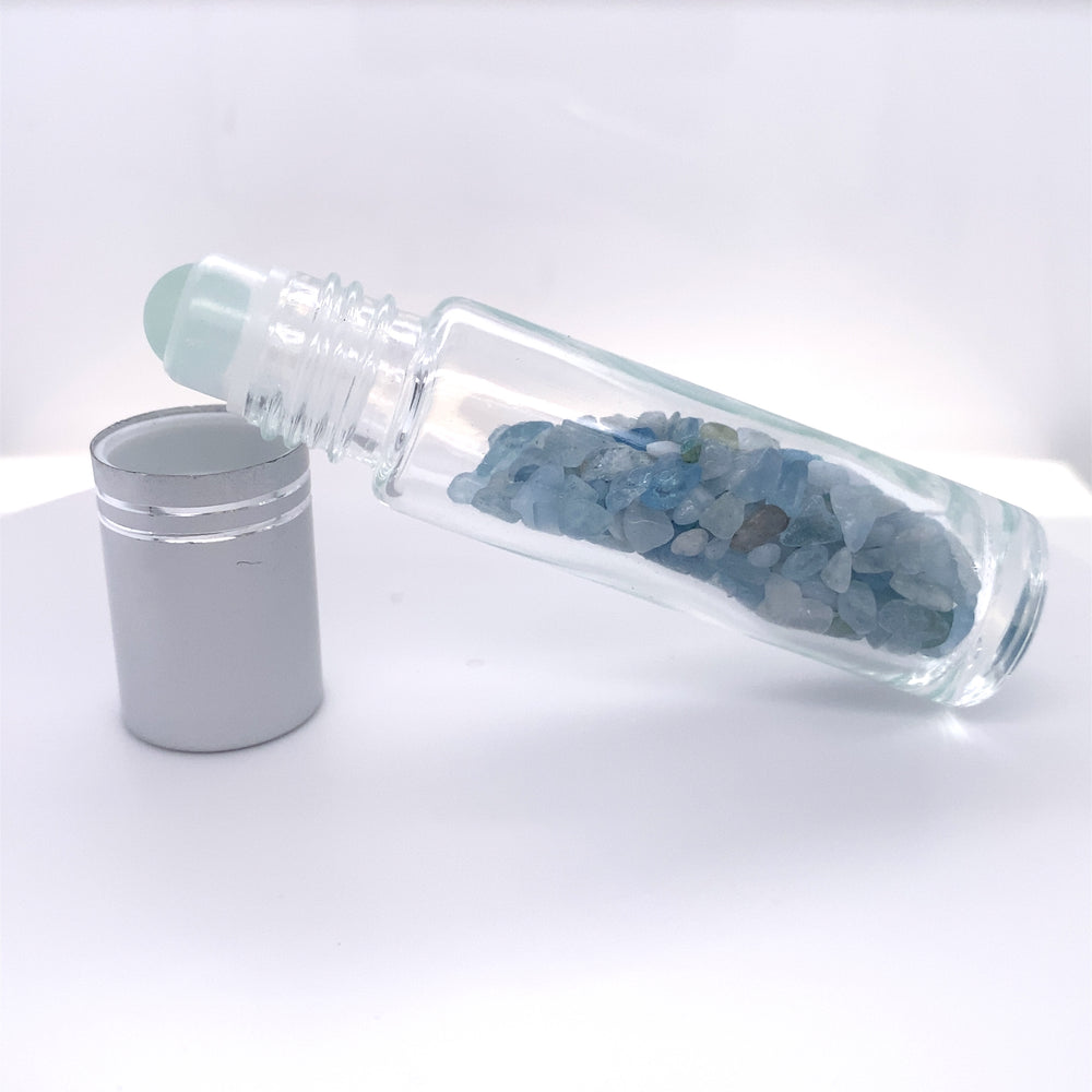 
                  
                    A glass bottle with blue crystals and a tin can next to it, perfect for self care relaxation or Stone Essential Oil Roller storage.
                  
                