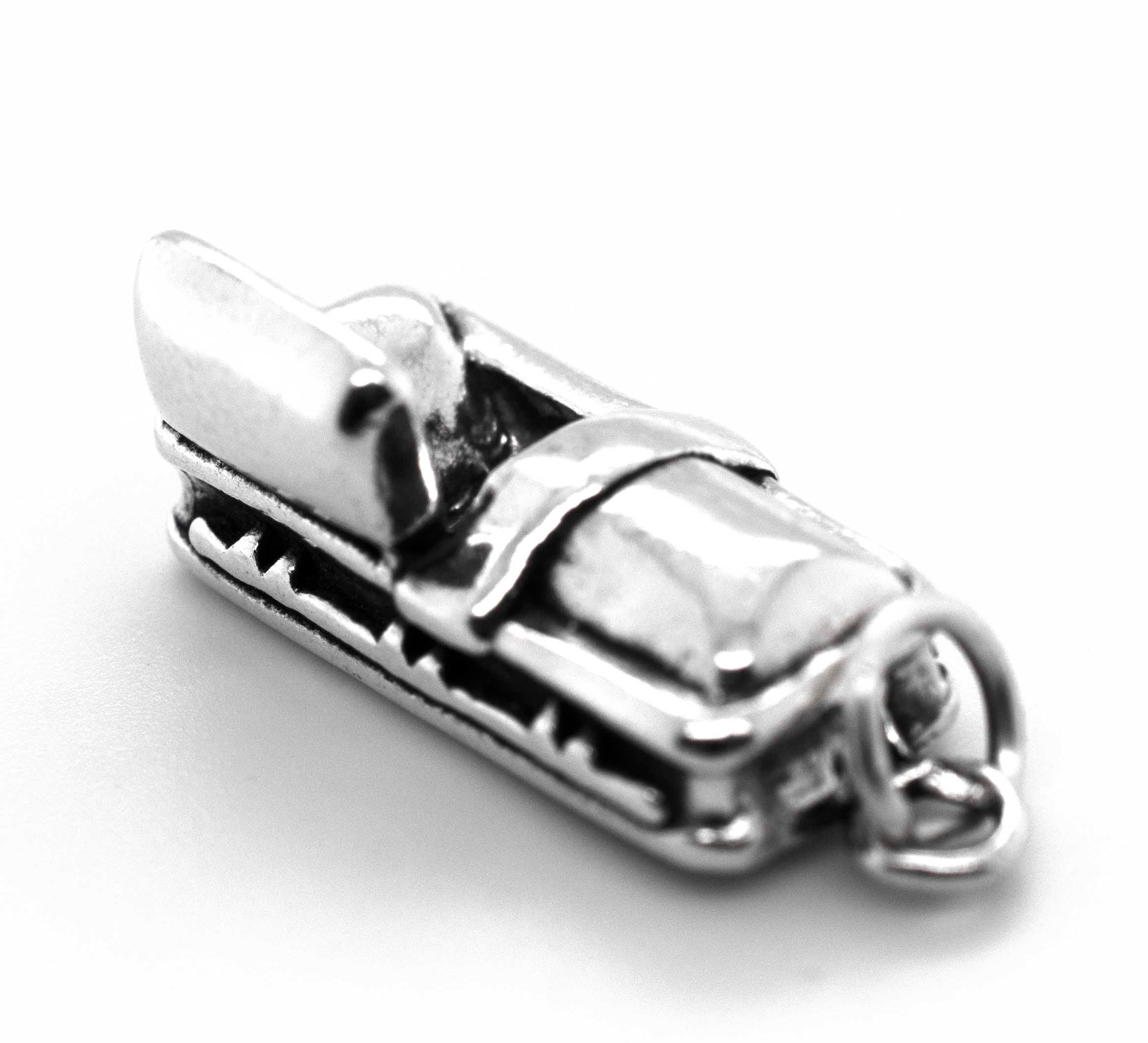 A Super Silver Open Coffin charm with a Halloween-themed seat on it.