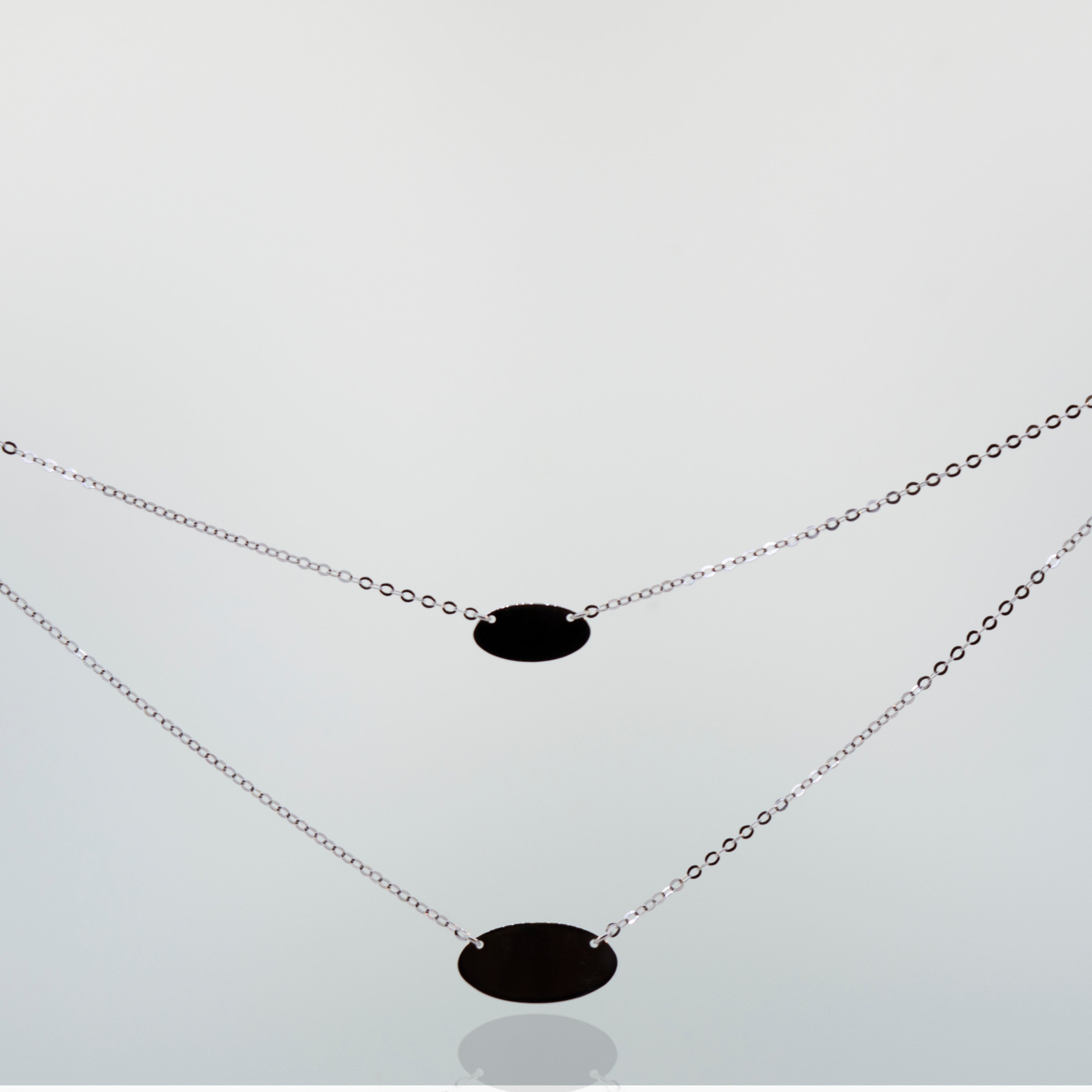 Two Elegant Sterling Silver necklaces with oval pendant discs, by Super Silver.