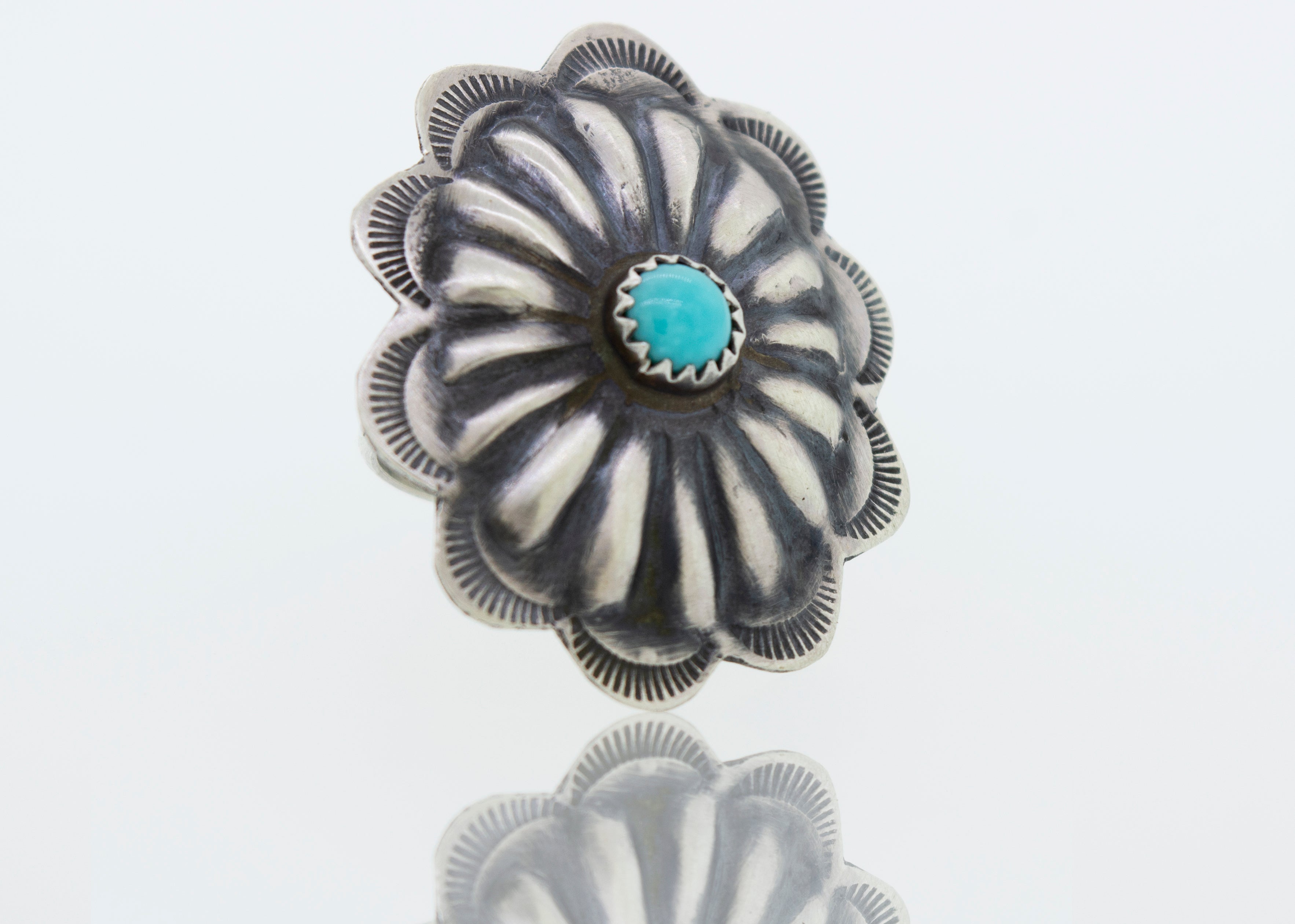 A cultural silver Native American Turquoise Flower ring.