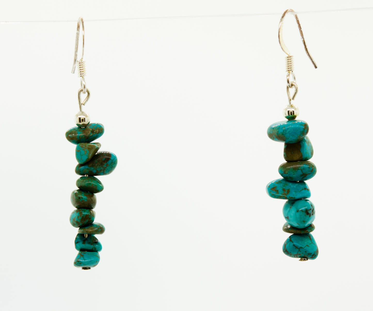 A pair of Super Silver American Made Colorado Turquoise earrings on a white background.