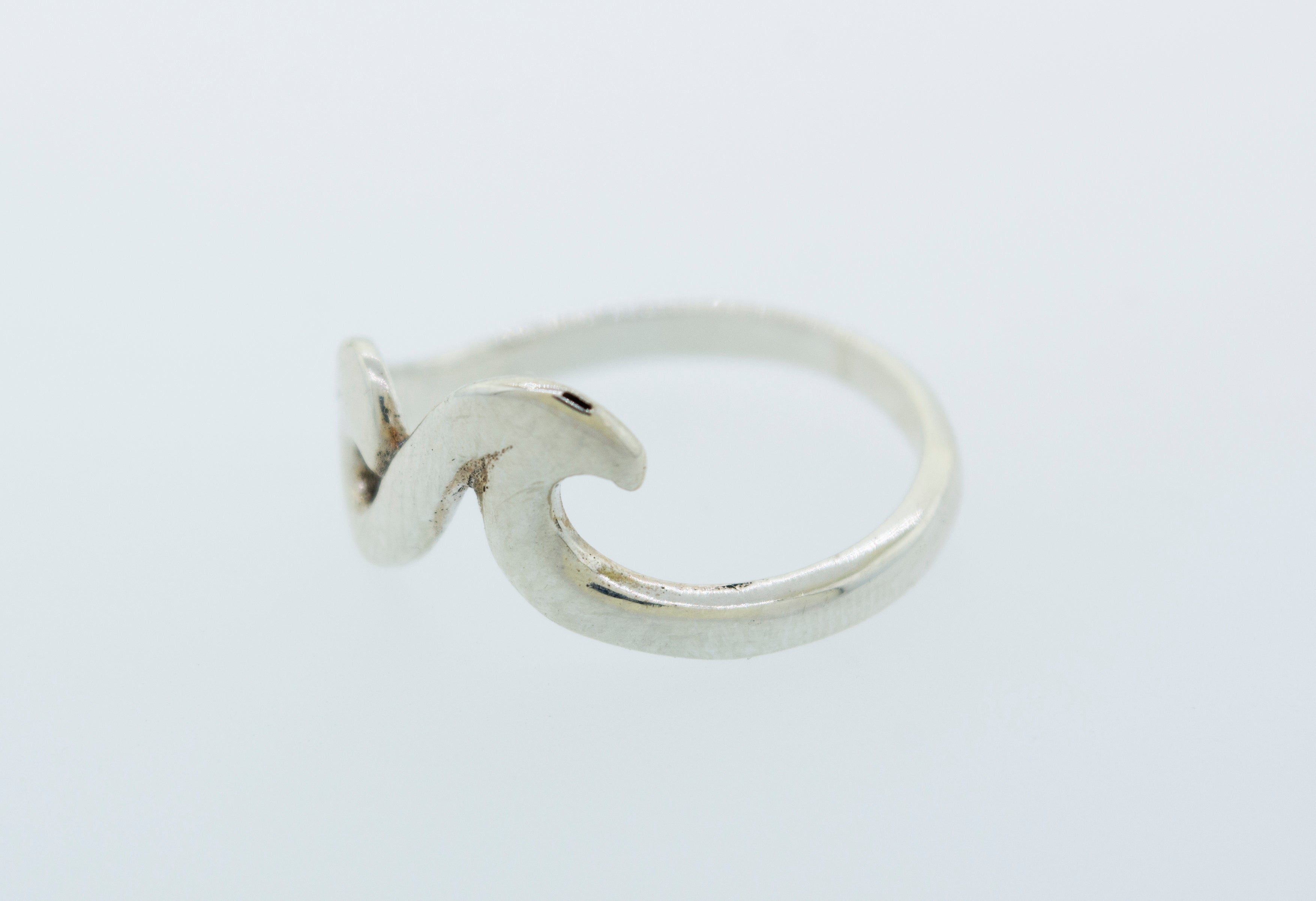 A minimalist silver Two Waves Ring with a modern wave design, inspired by the coastal beauty of Santa Cruz.