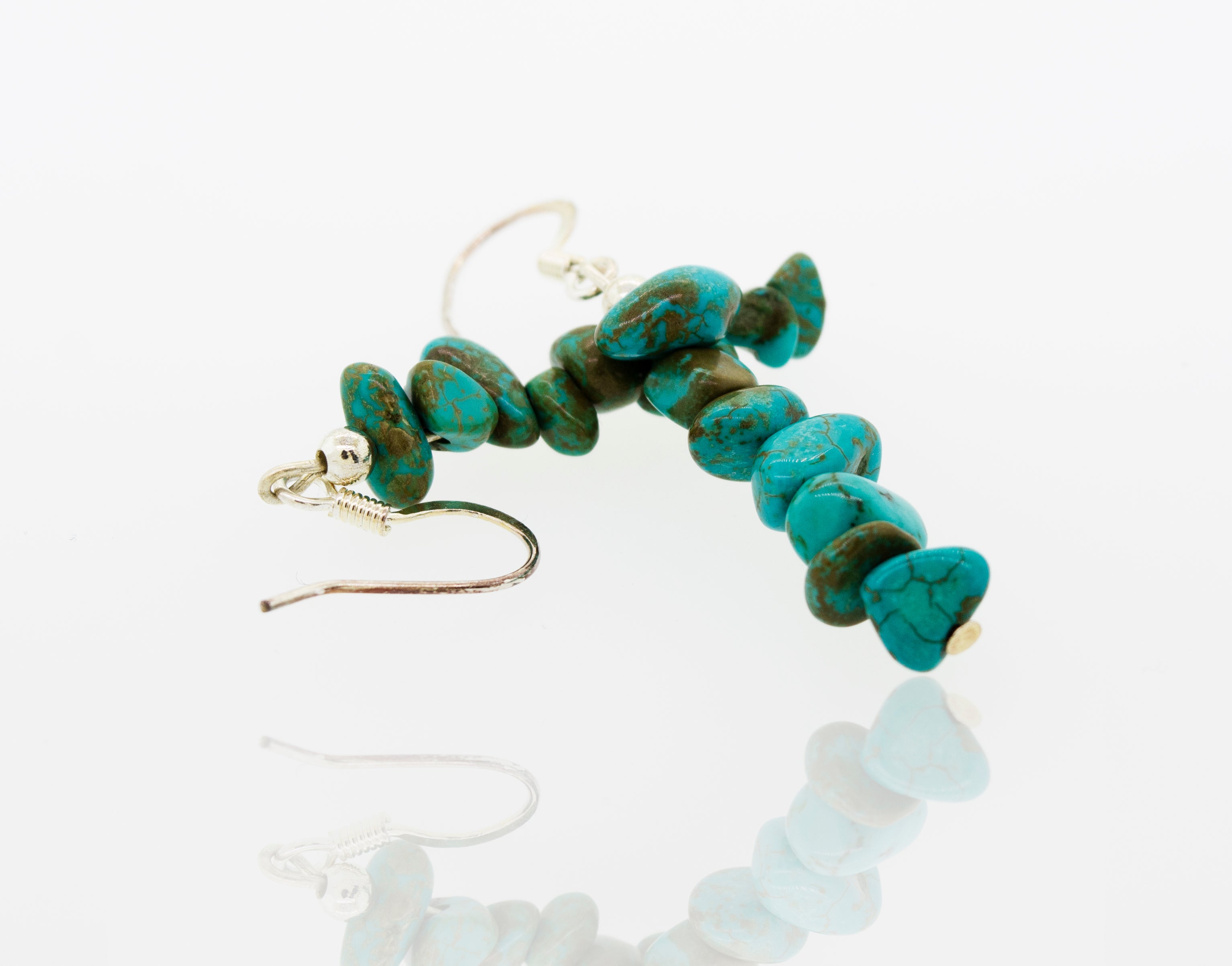 A pair of Super Silver American Made Colorado Turquoise Earrings on a white surface.