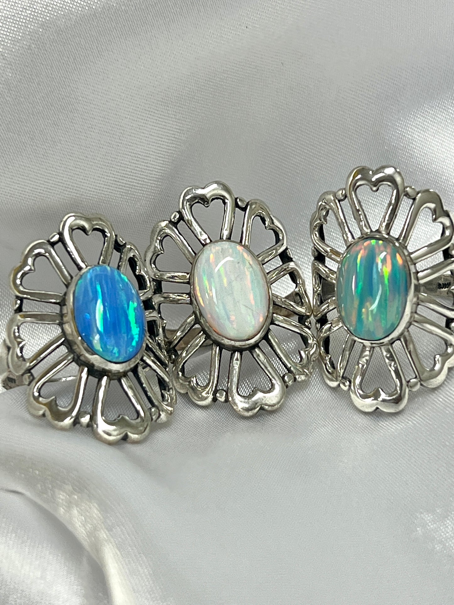 Three American Made Opal Flower Rings with Heart Shaped Petals, handcrafted by Super Silver.