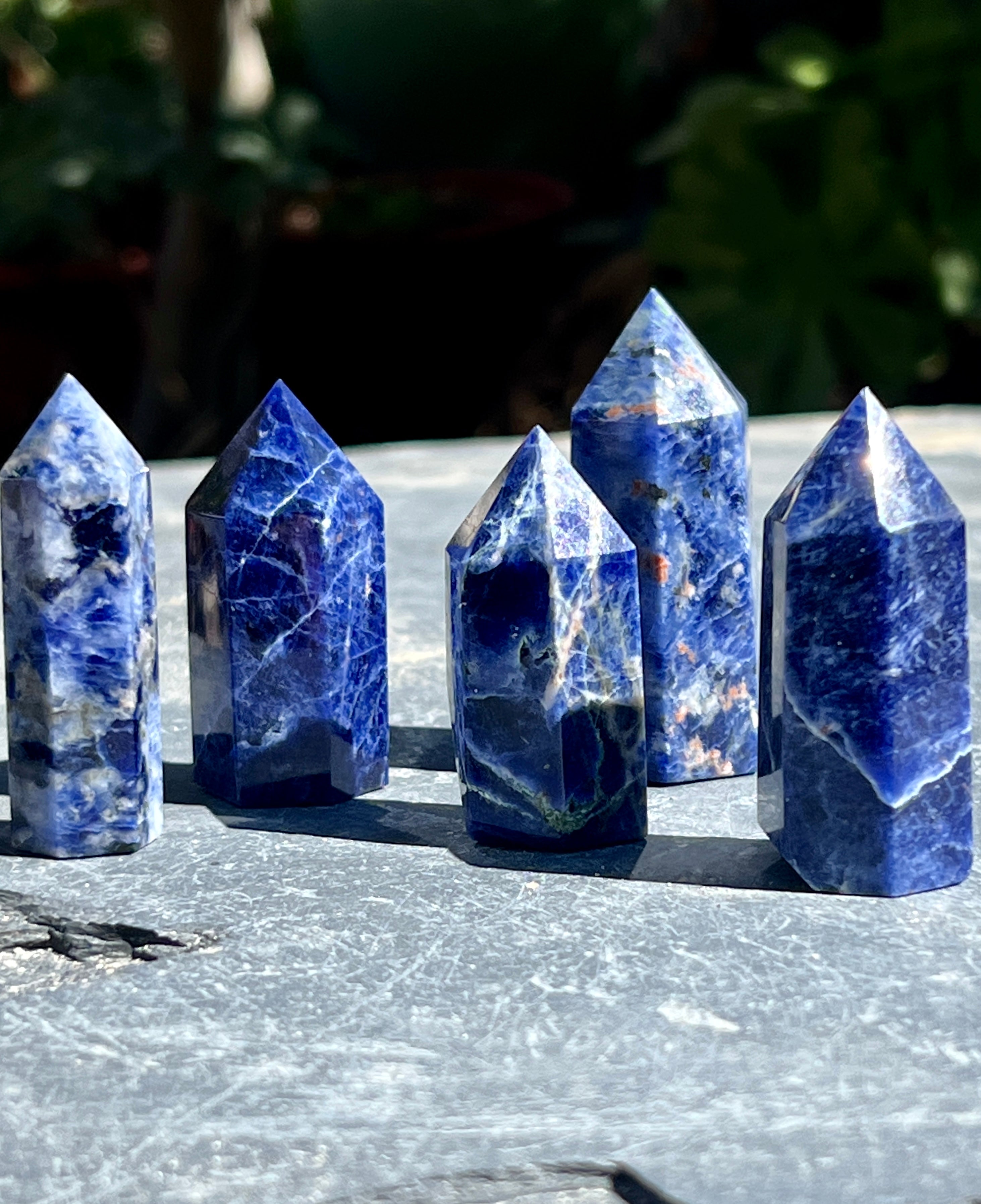 A group of Sodalite Obelisks on a table.