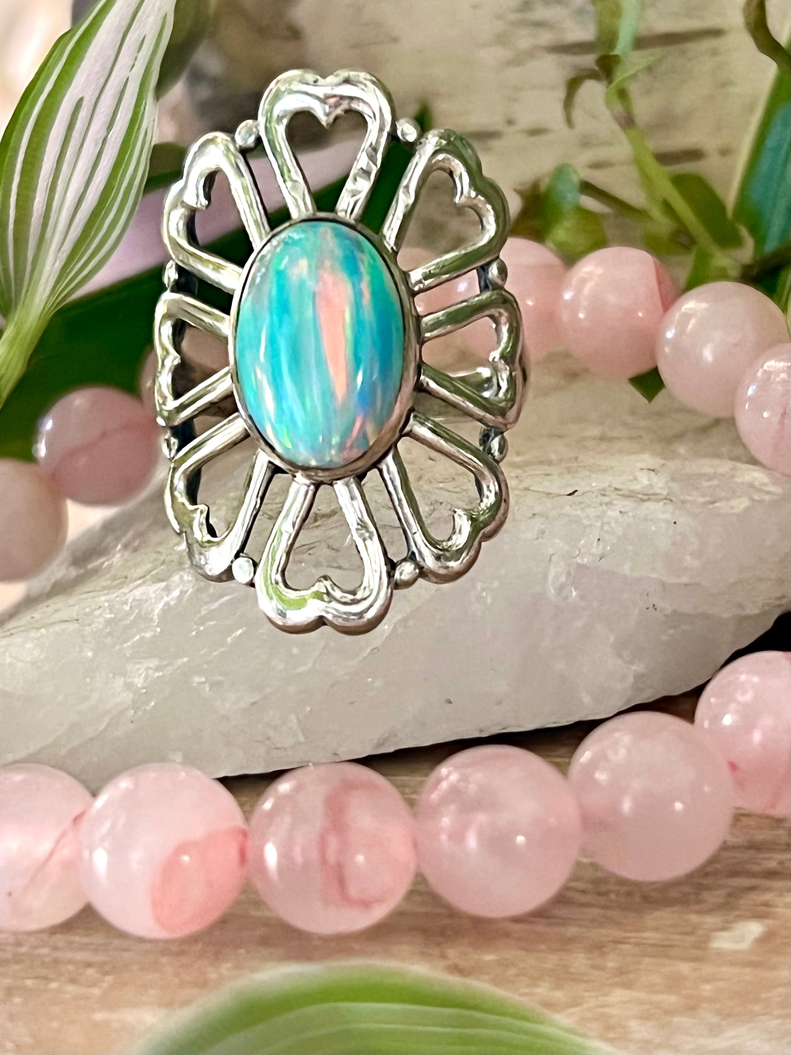 A handcrafted Super Silver American Made Opal Flower Ring with Heart Shaped Petals adorned by pink beads.