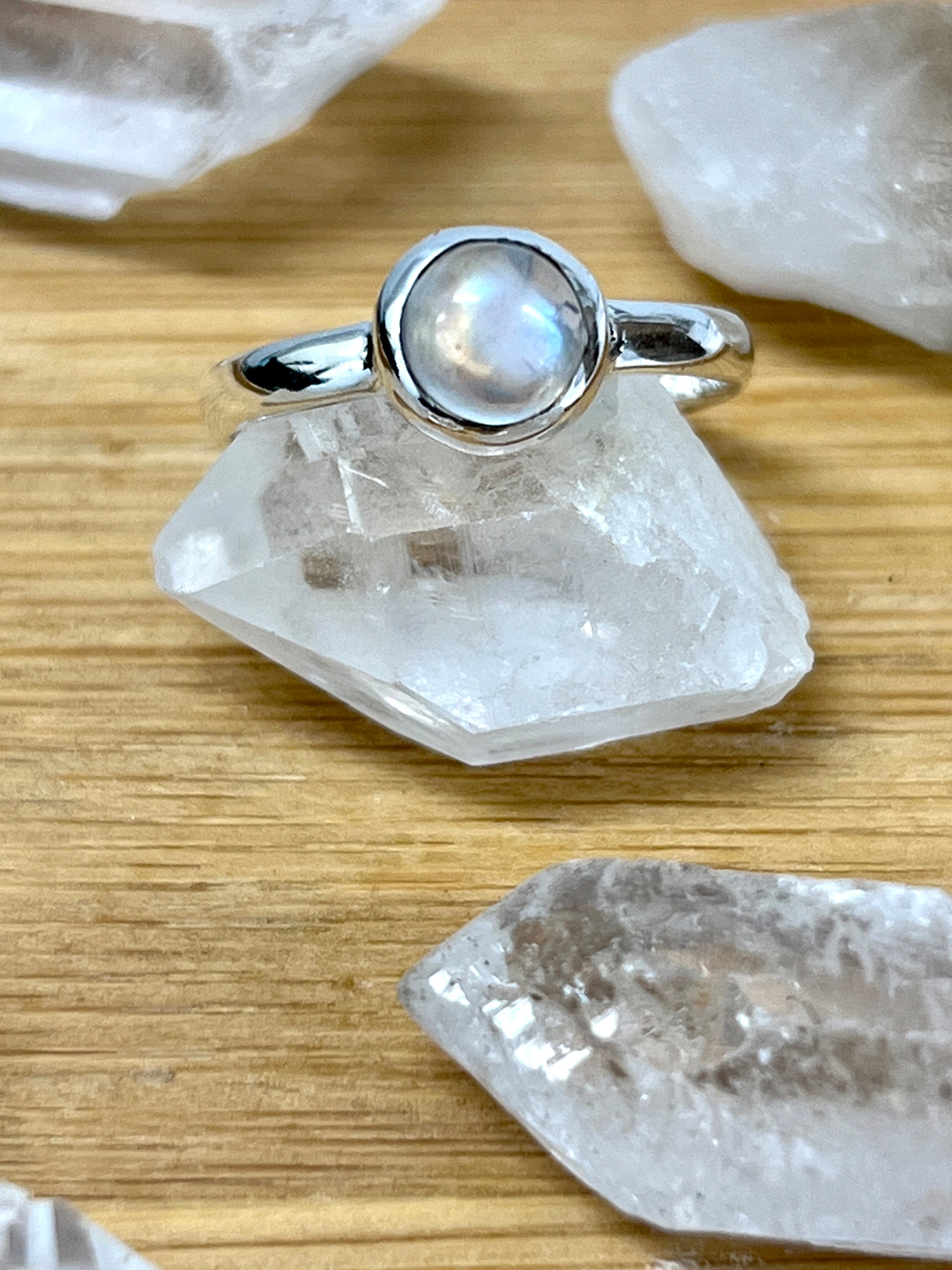 A Simple Moonstone and Labradorite Stacking Ring by Super Silver with a moonstone on top of crystal stones.