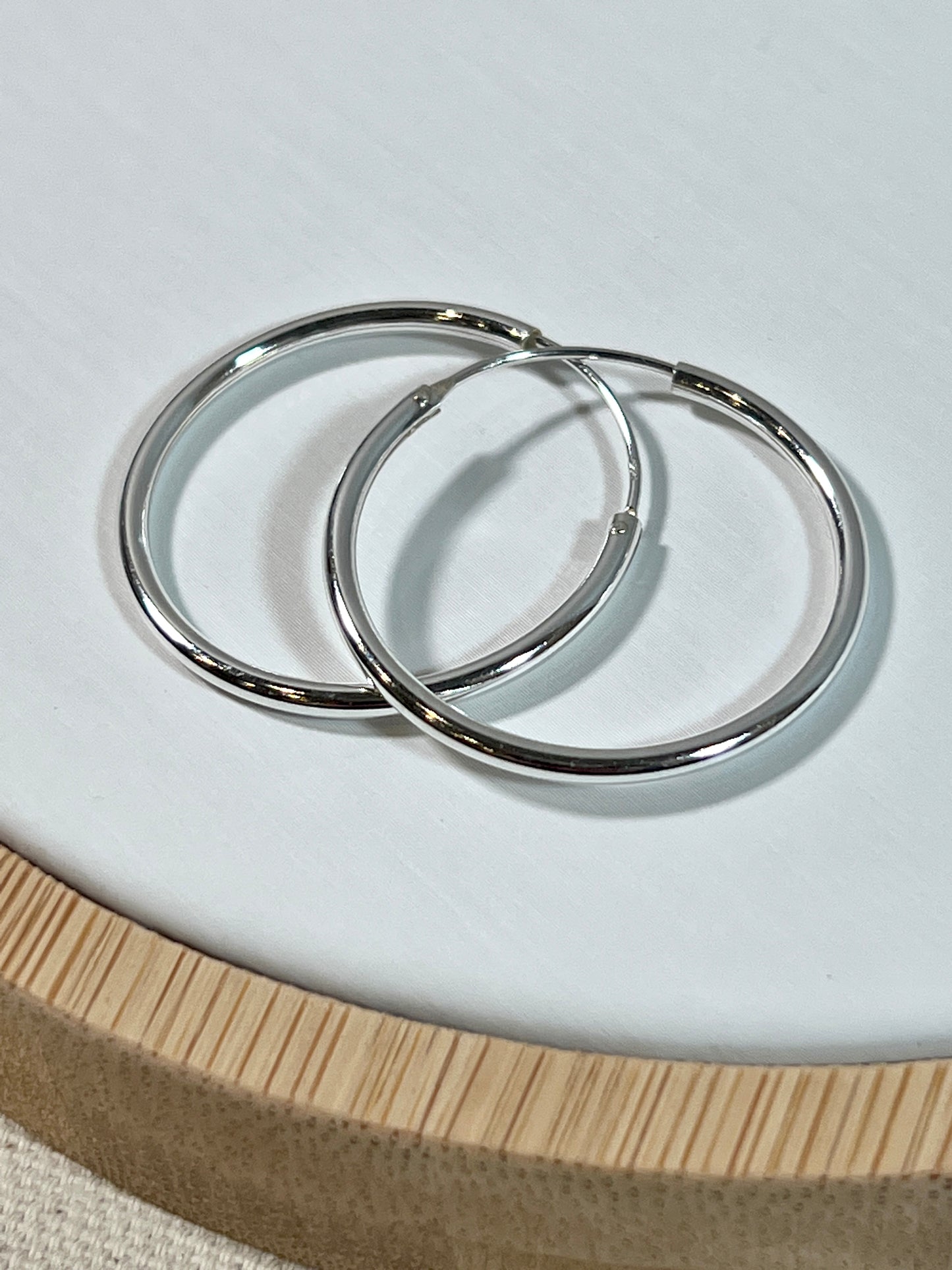 A pair of Super Silver Infinity Hoop 2mm x 30mm earrings.