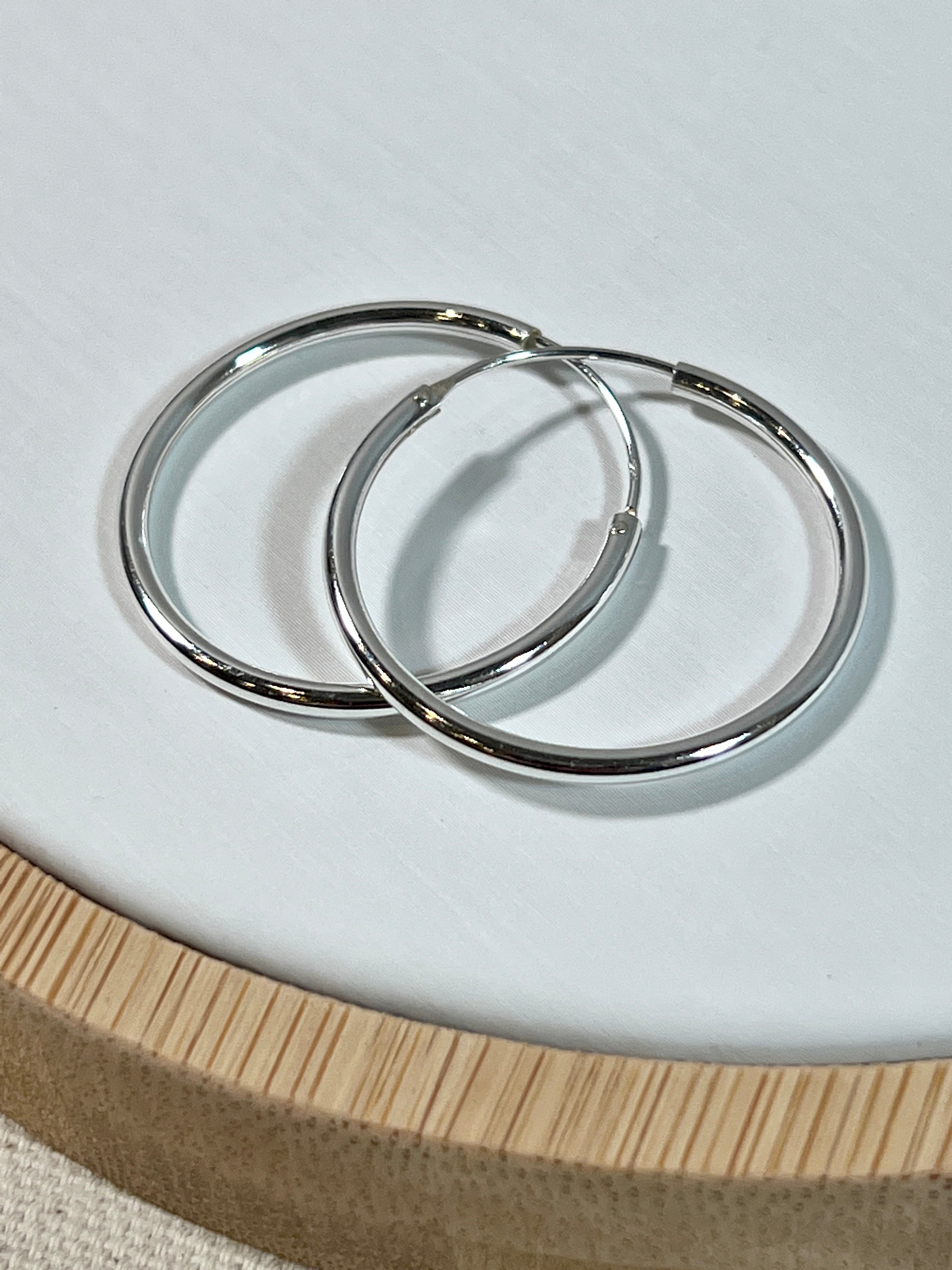 A pair of Super Silver Infinity Hoop 2mm x 30mm earrings.