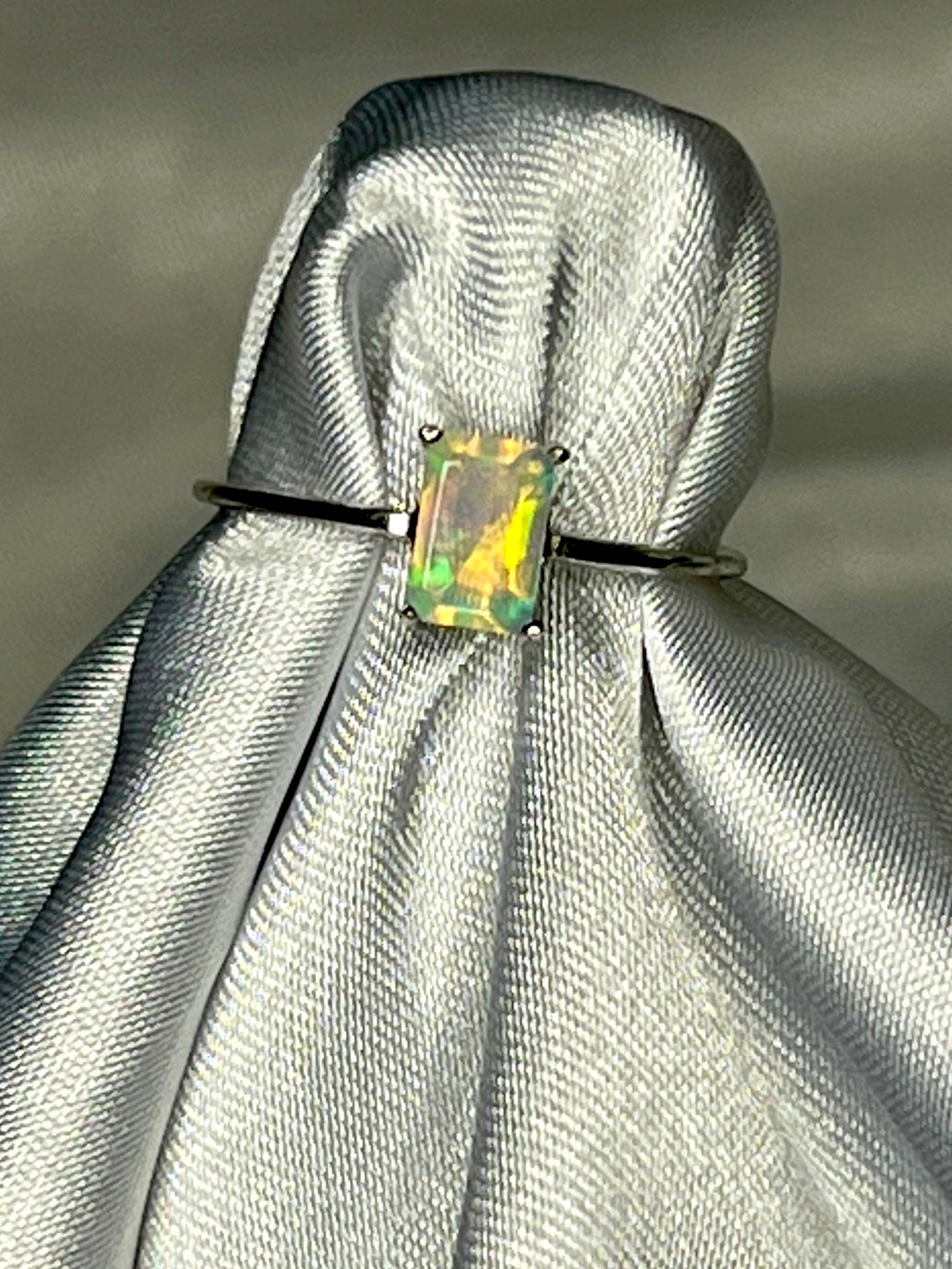 An elegant Cushion Cut Ethiopian Opal Ring with a statement green opal on it.