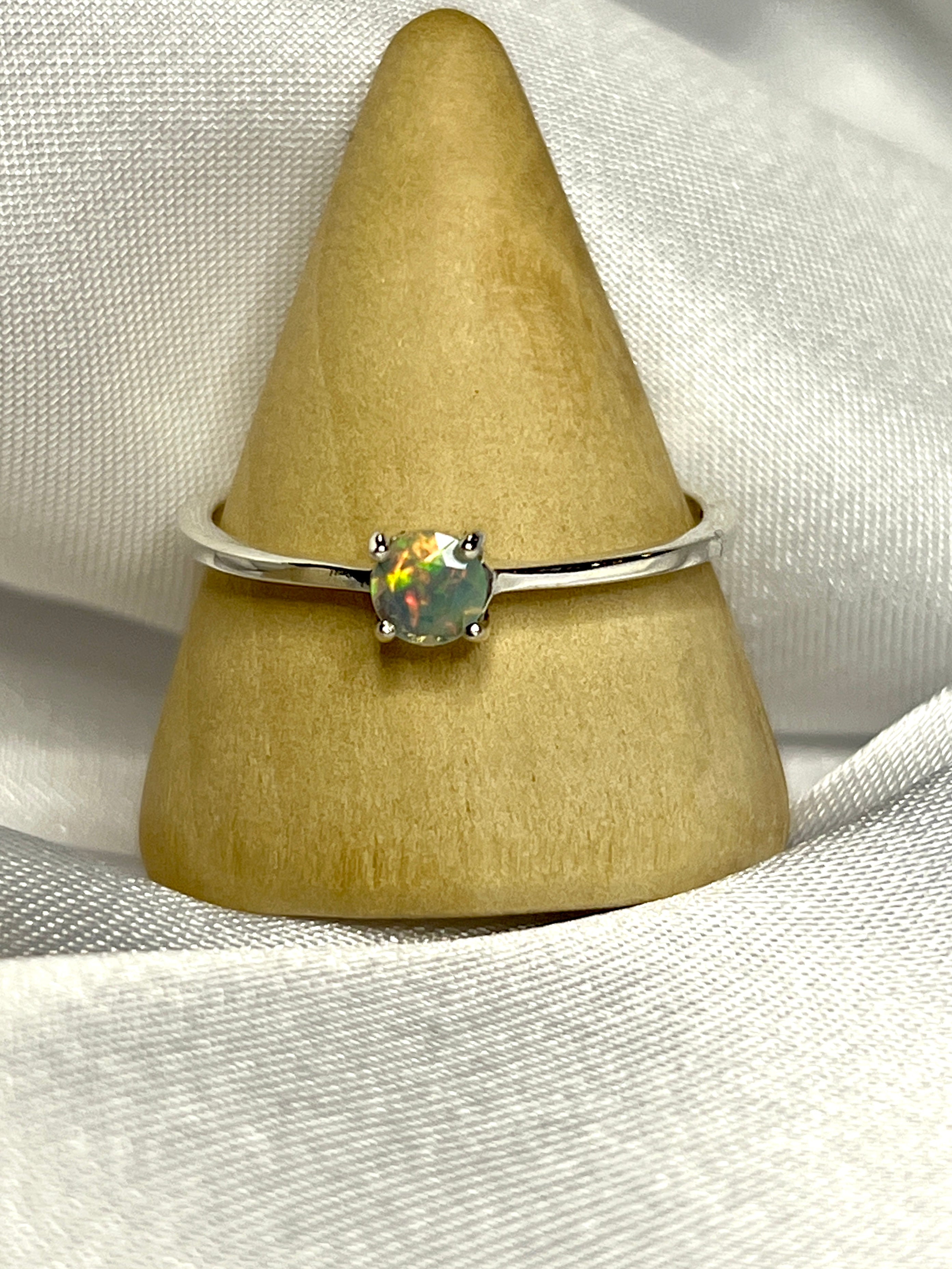 An elegant Dainty Prong Set Facet Cut Ethiopian Opal Ring, making a subtle statement.